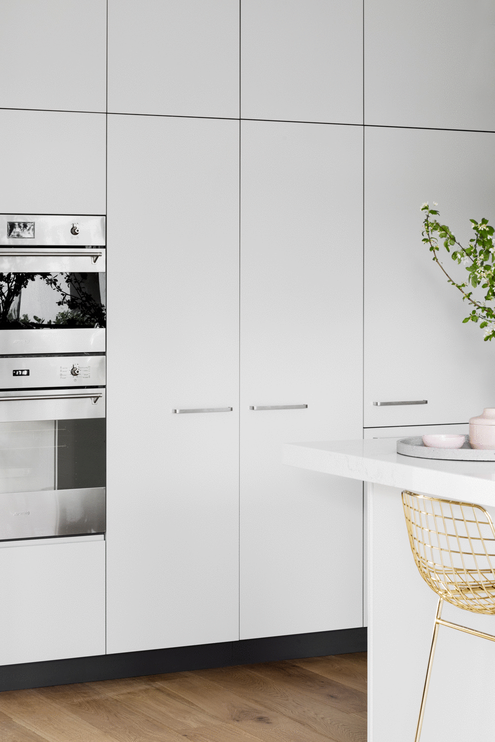 In the tall storage a Smeg oven tower is within easy reach of benchtop, which is kept clear by a handy appliance cabinet with inbuilt utility bench and lighting. For storage, a Häfele pantry sits next to a compact integrated Miele fridge/freezer whi…