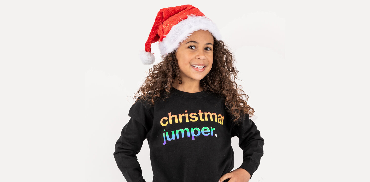 girl wearing black coloured pride jumper wearing christmas hat