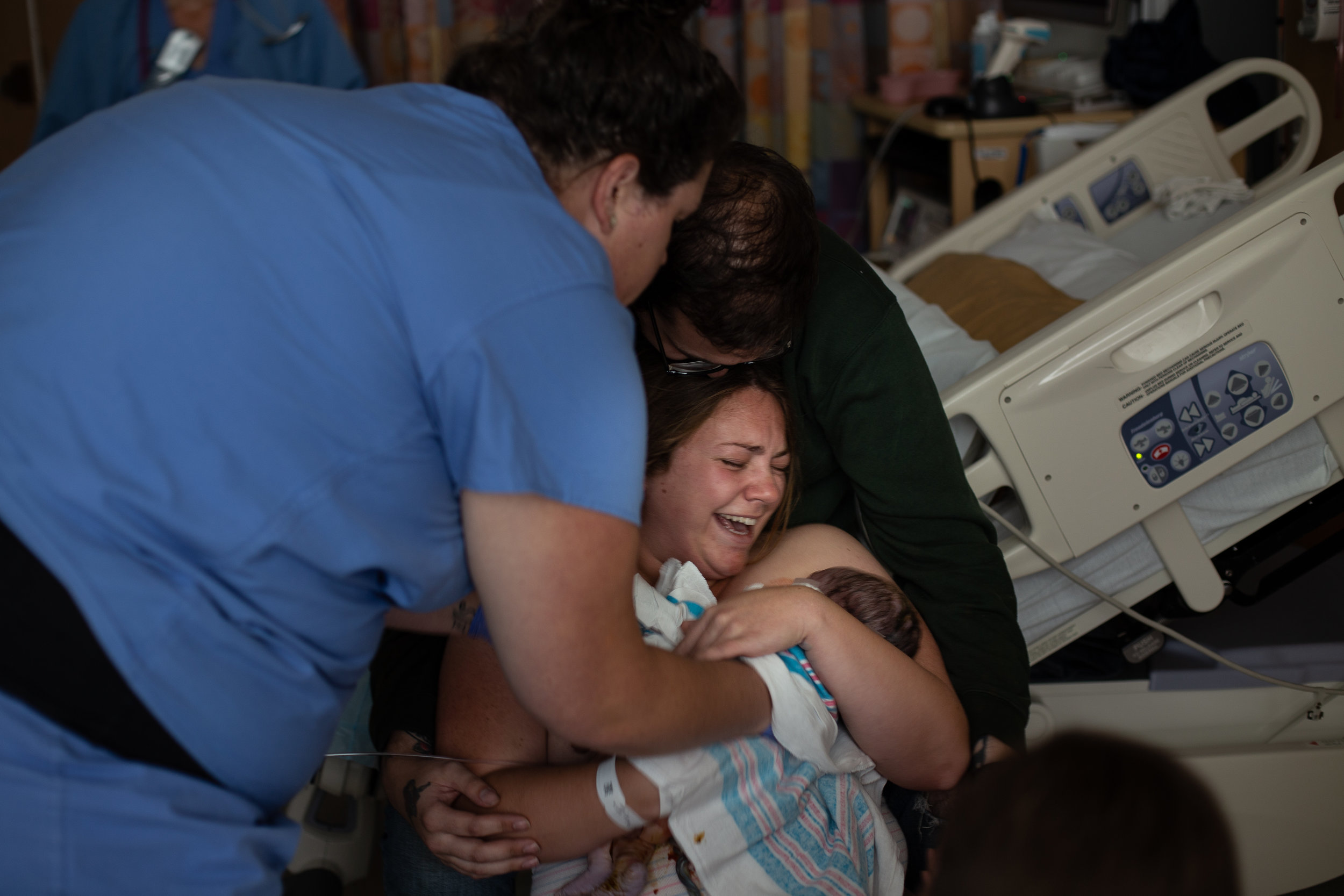 Woman holds her baby for the first time in a hospital birth. 