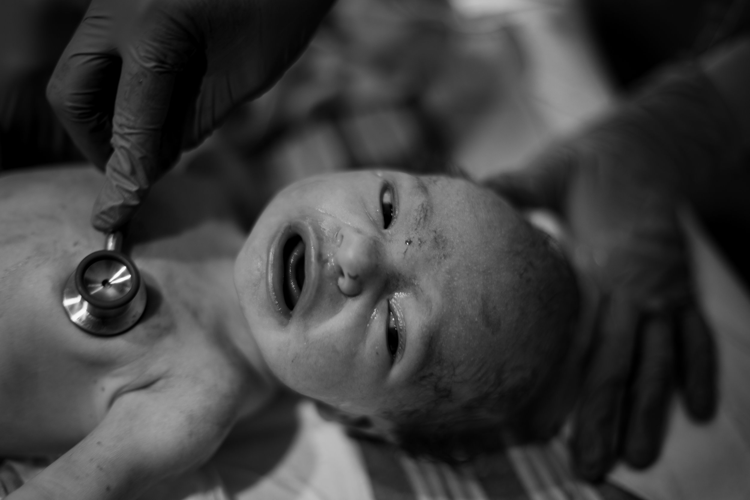 stethoscope on newborn baby.