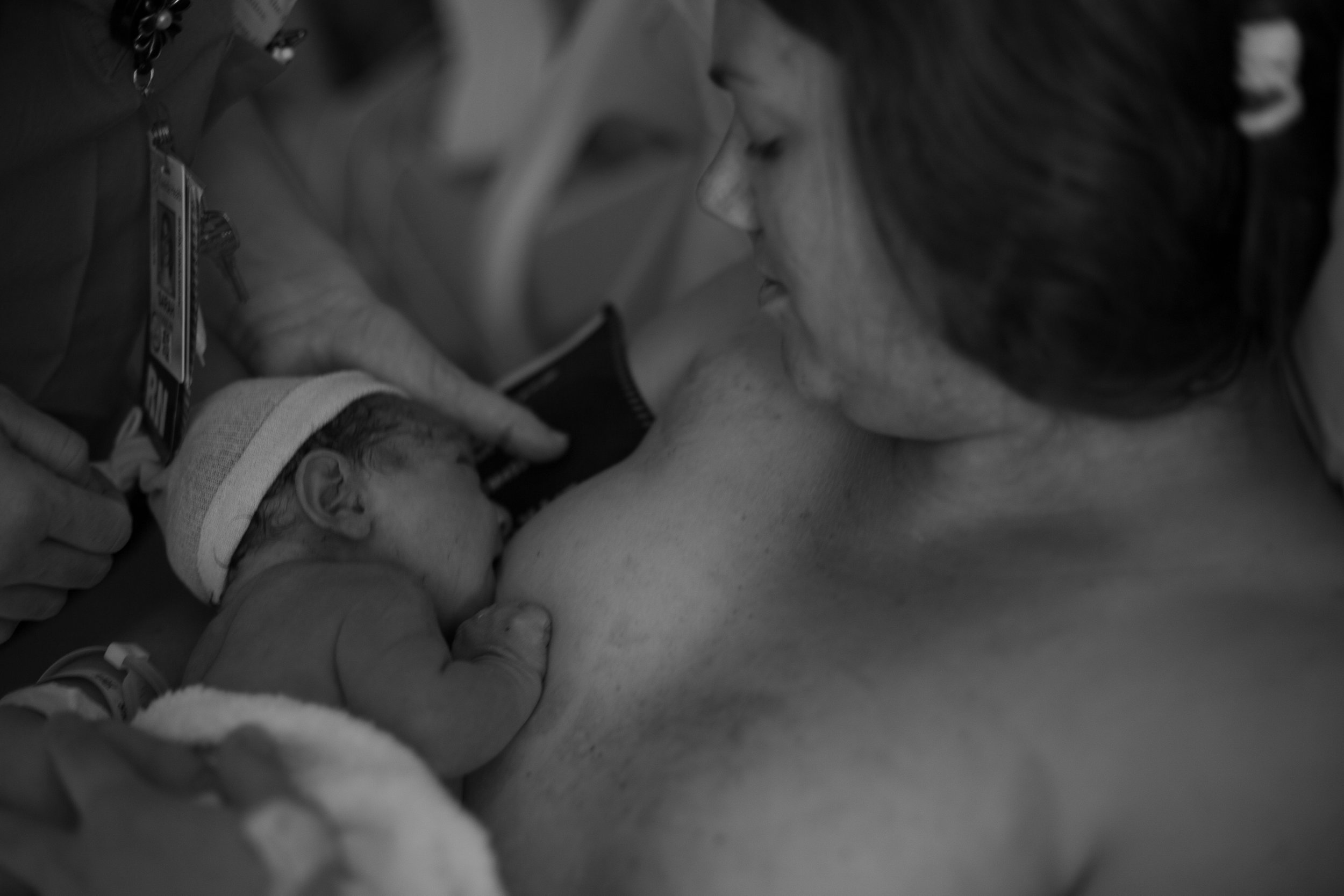 Black and white image of a new baby breastfeeding.