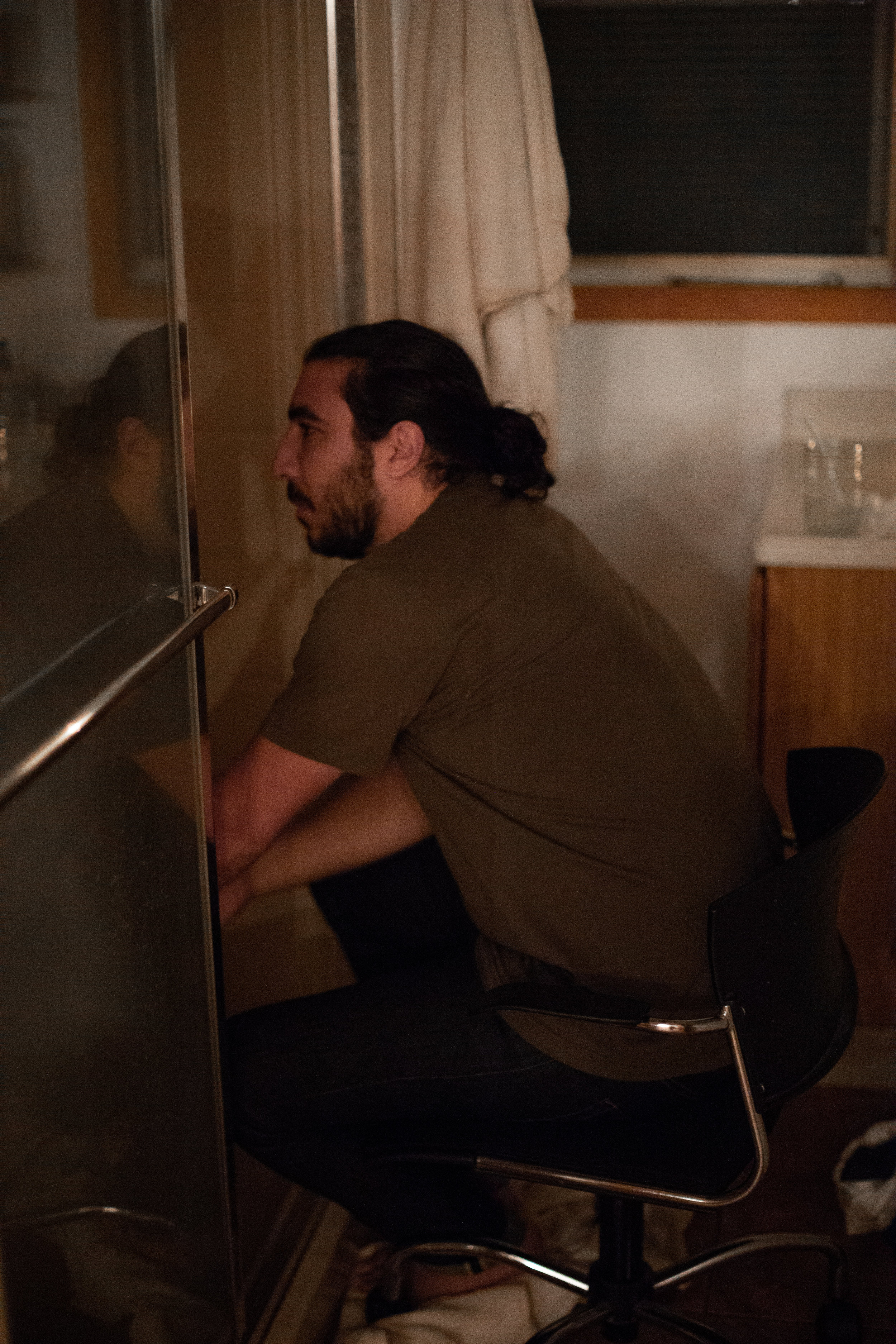 Husband providing labor support to his wife while he is in the shower.
