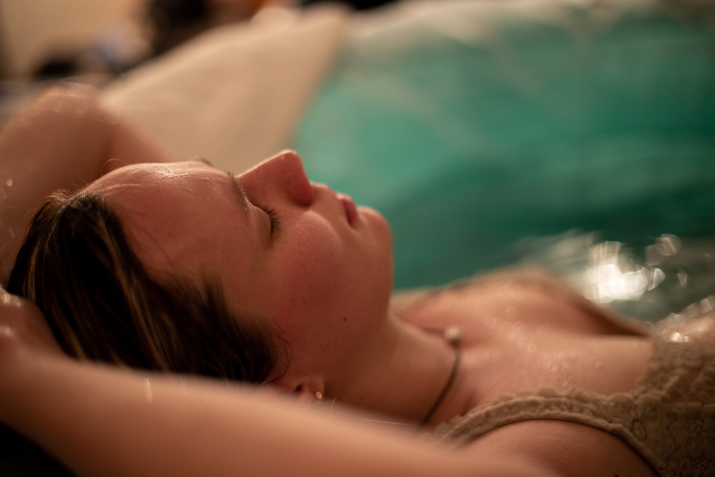 Woman sleeping peacefully in a birth pool.