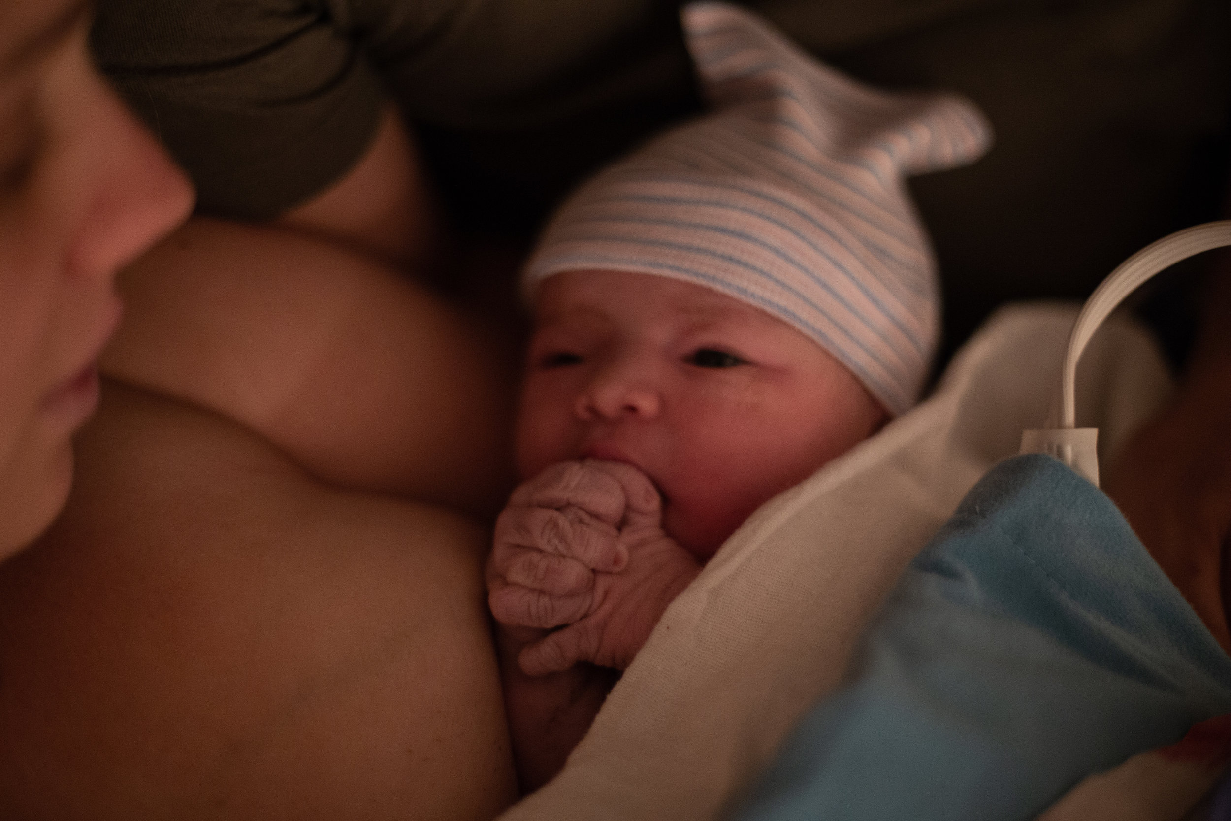 A newborn baby with her hands folded in prayer. 