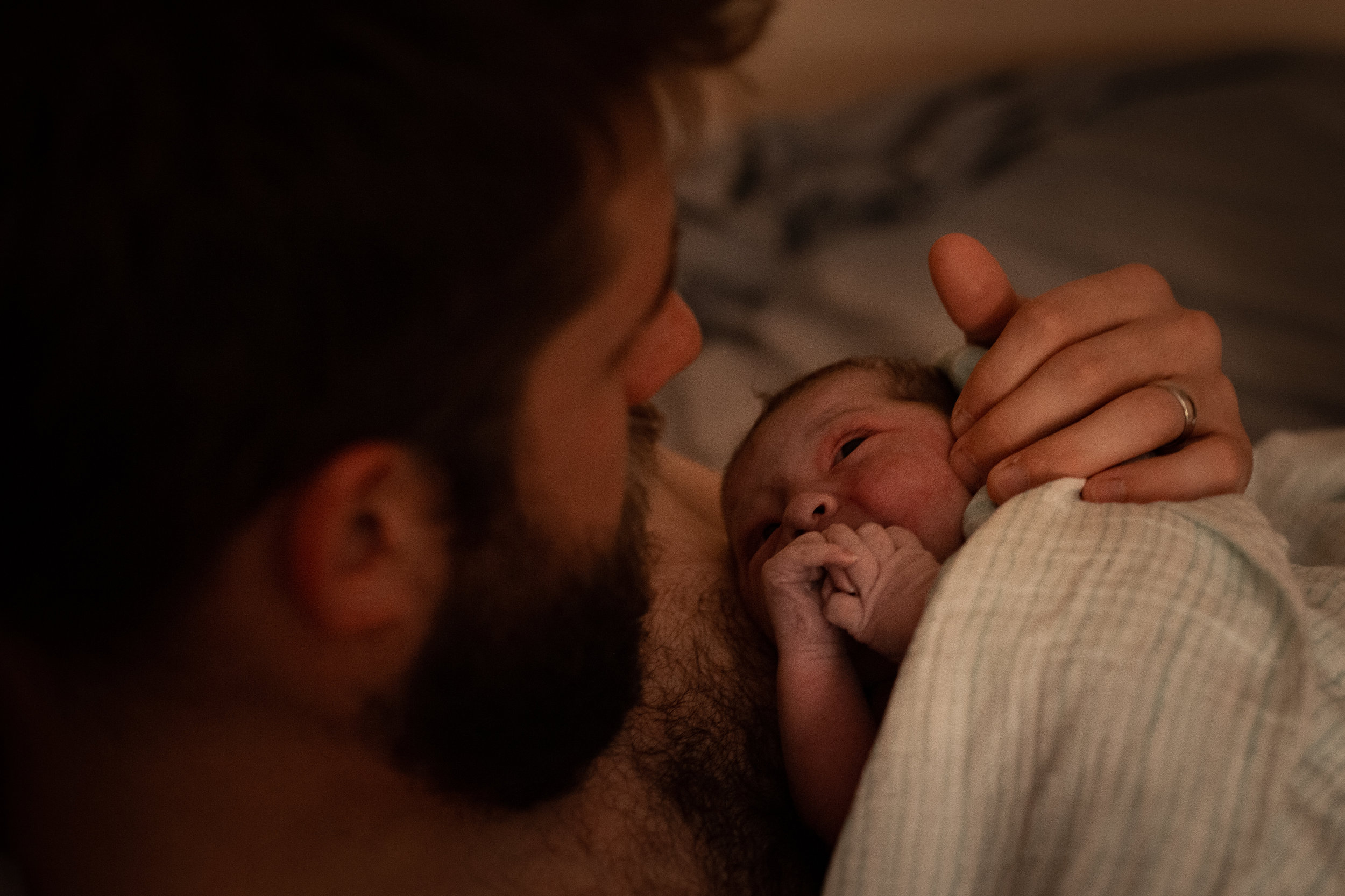 Father doing skin to skin with his newborn baby 
