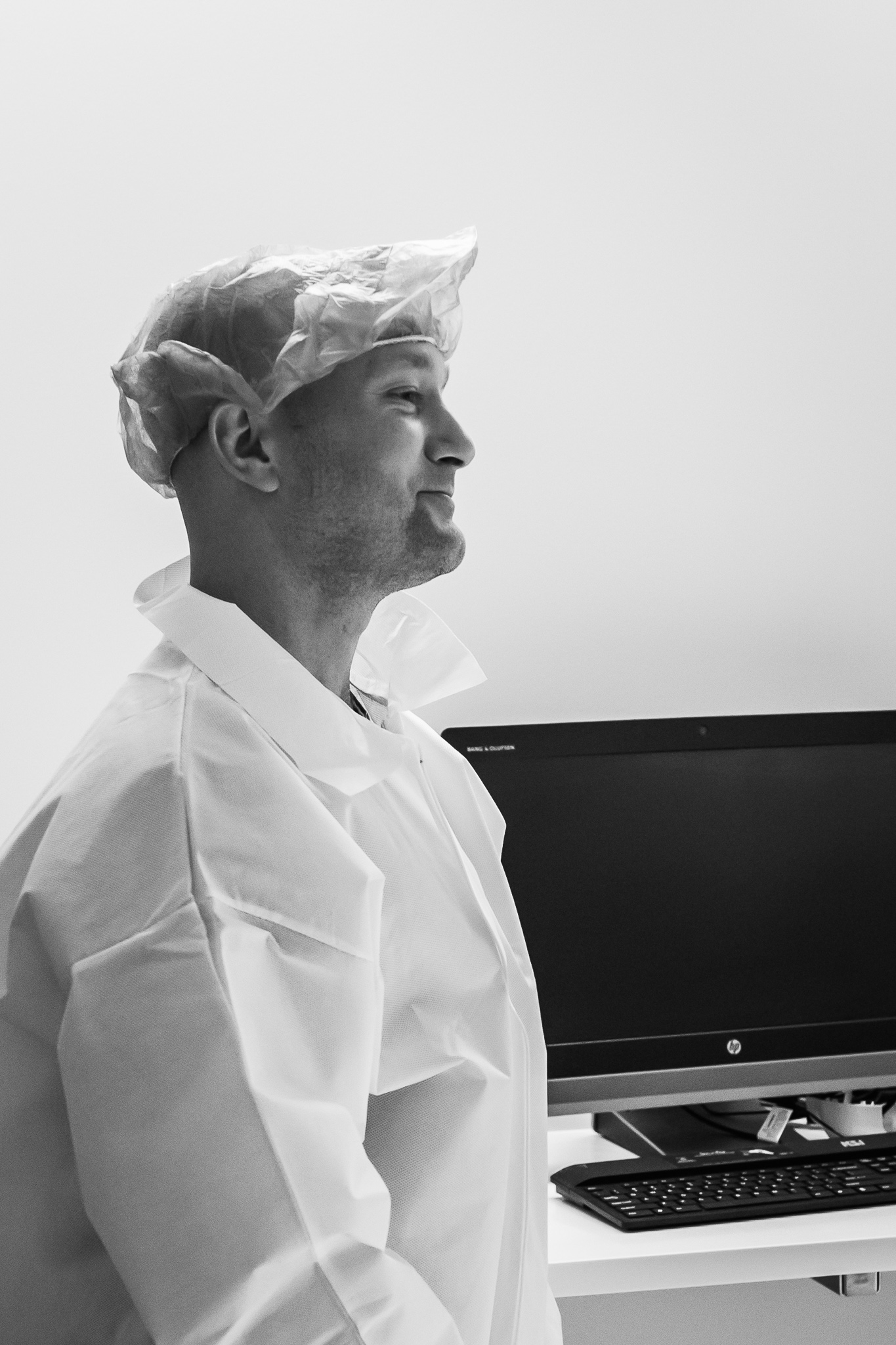 Black and white photo of a man with surgery scrubs.