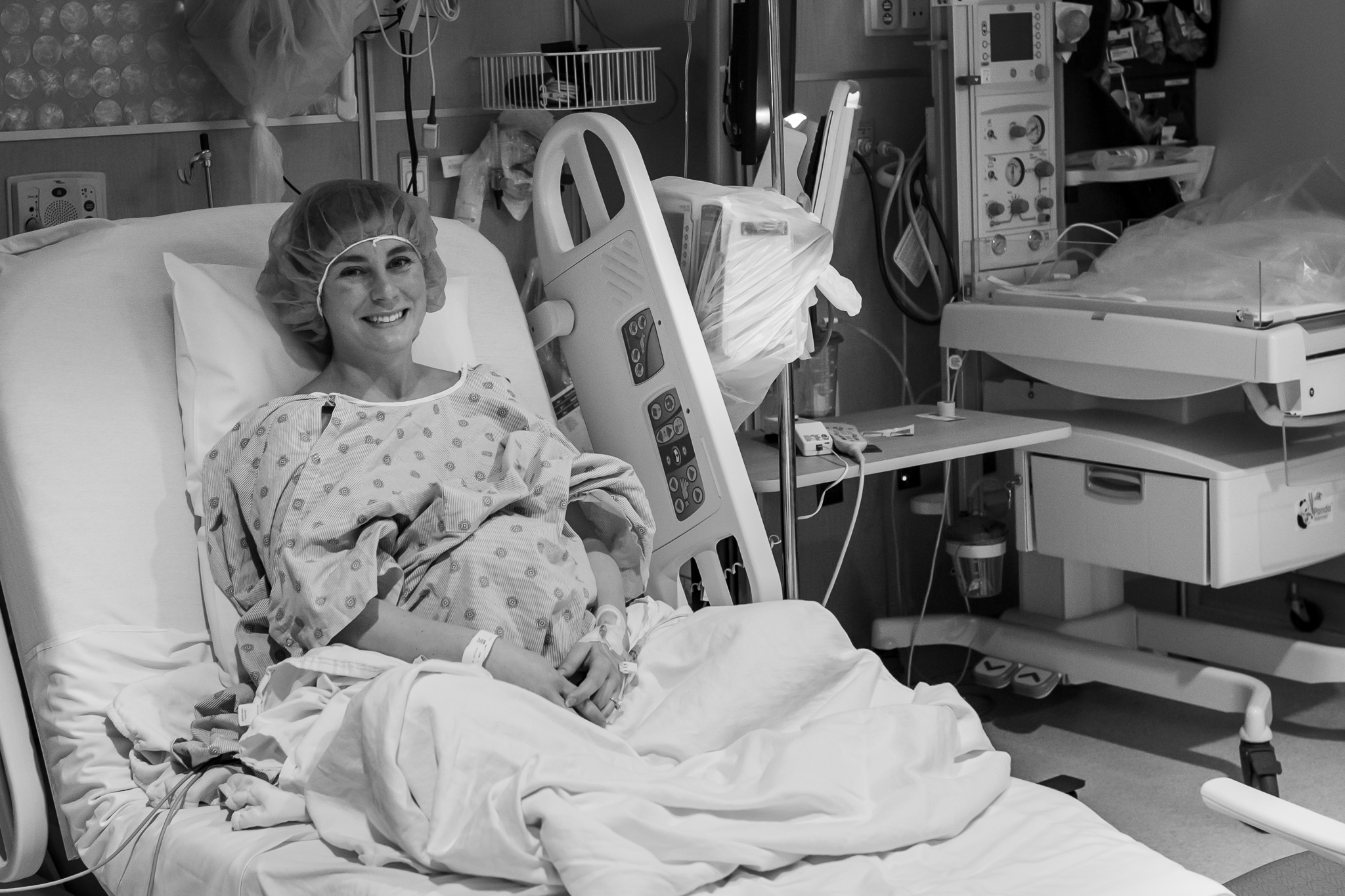 Black and white photo of a pregnant woman waiting for a c-section. 