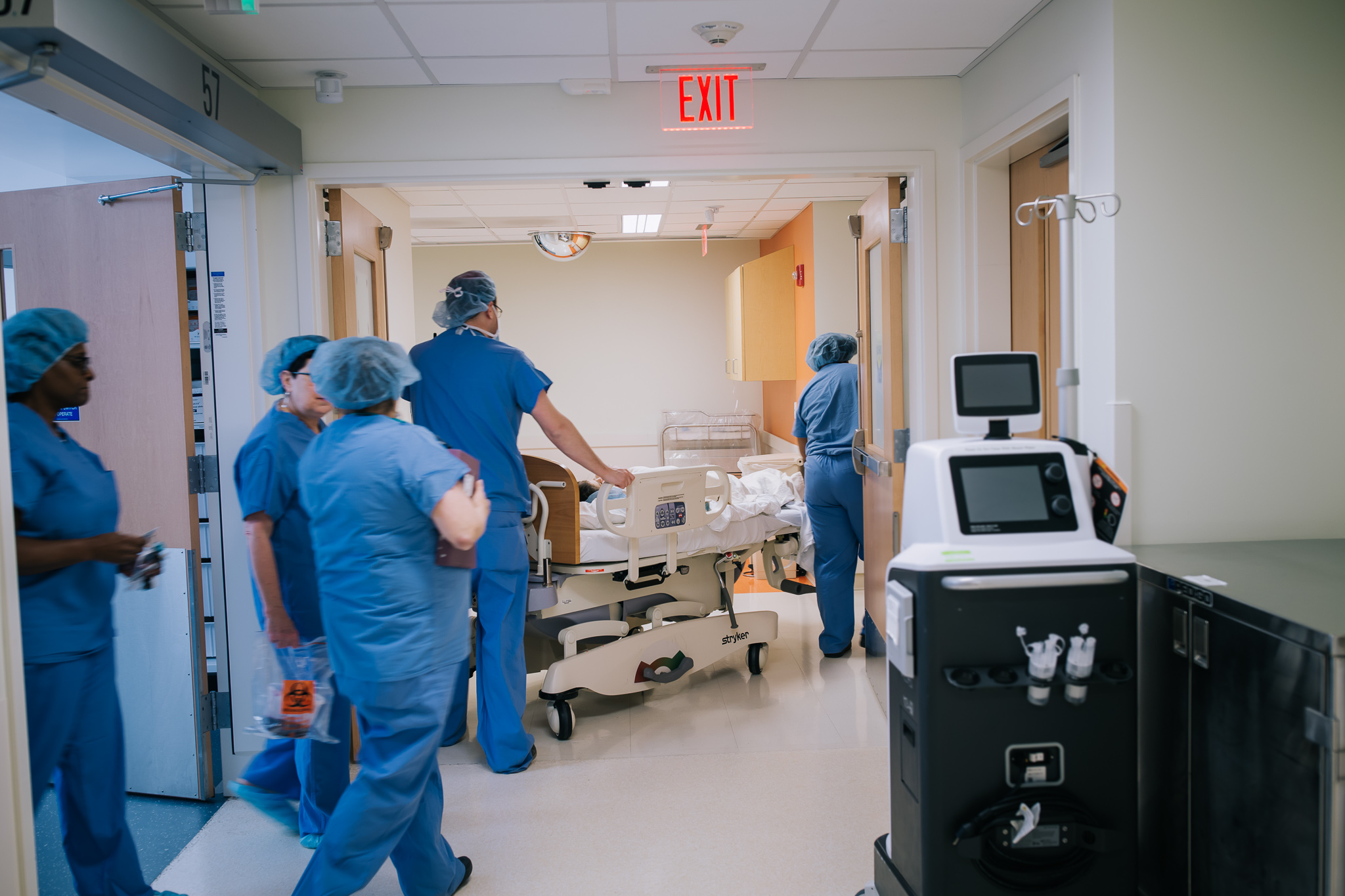 Wheeling a mom out of the operating room after a cesarean section.