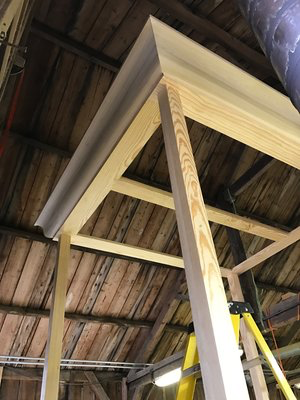 Four poster bed with large cornice being assembled