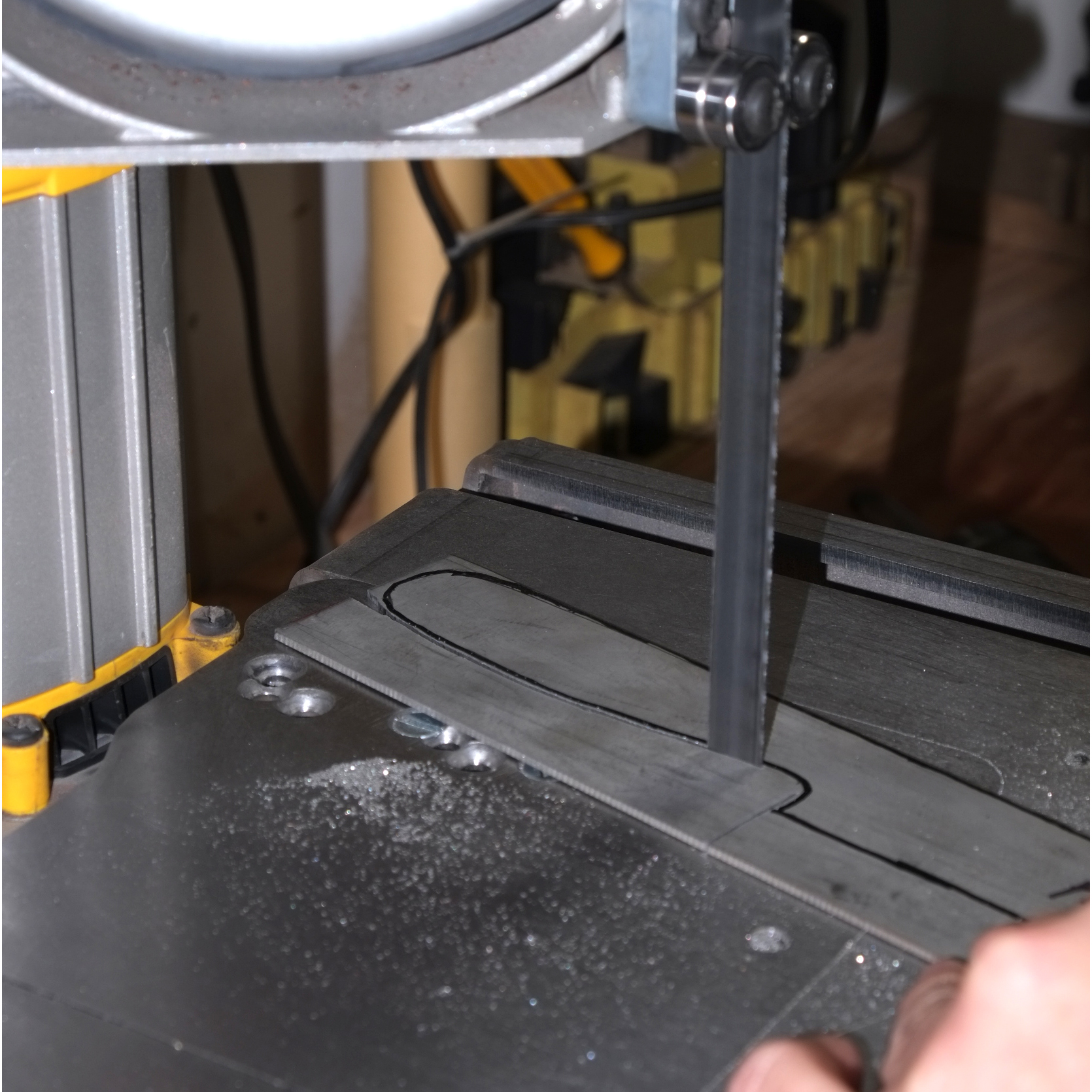 An outline is traced from previously cut knife templates and cut out with the band saw.