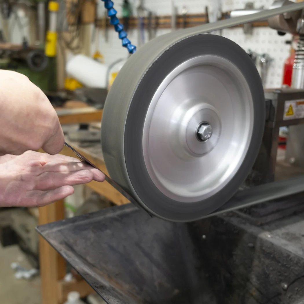 The blades are given a final polish on a felt belt.