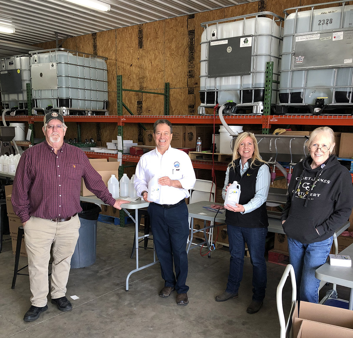 AJ and Peg Hayes (far left and far right) of Casey Jones Distillery in Hopkinsville stand with Commonwealth Agri-Energy General Manager Mick Henderson and KyCorn Executive Director Laura Knoth after they packaged and labeled 200 bottles of ethanol s…