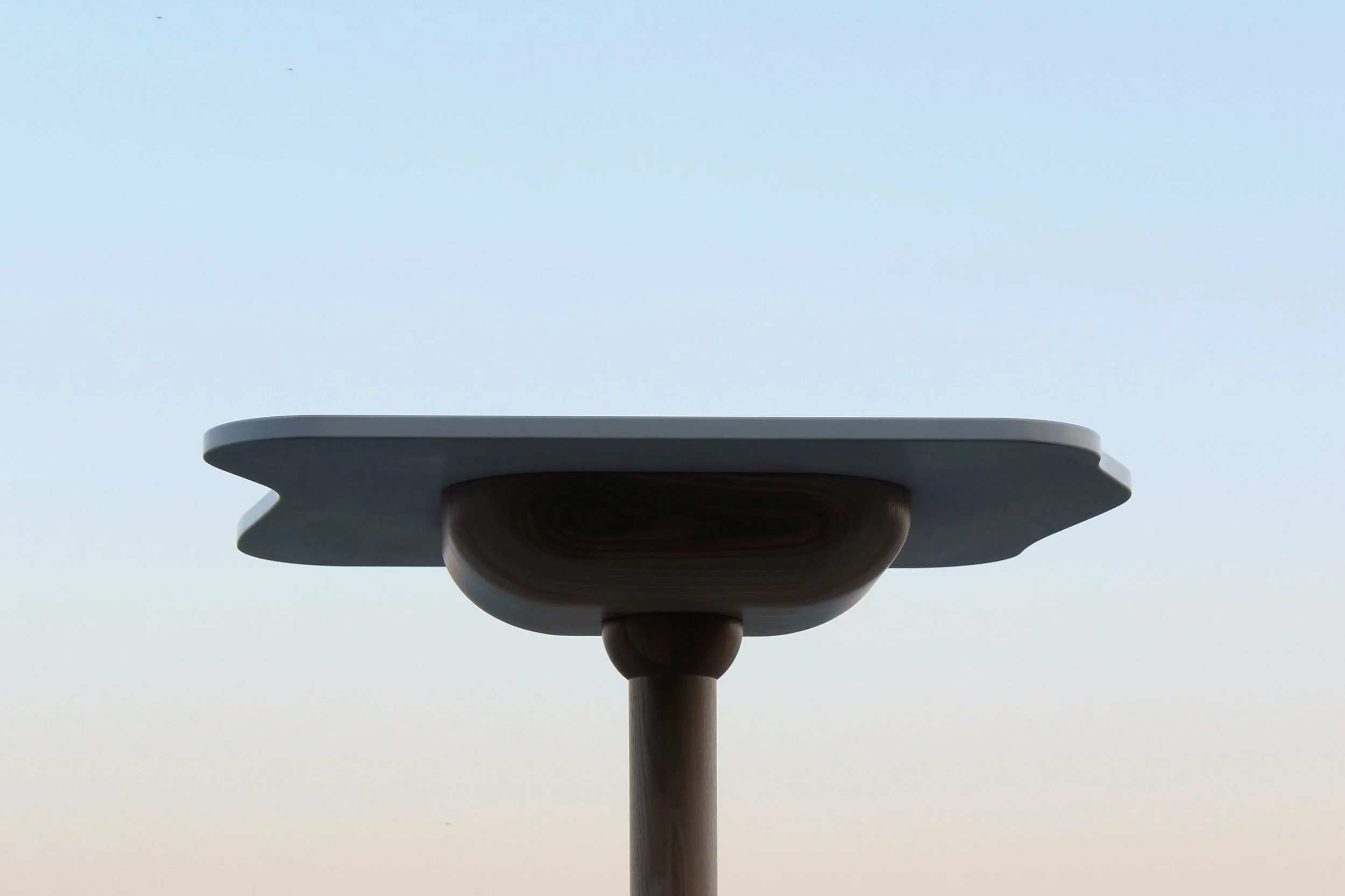The voluptuous underside of the table was carved to give enough volume to hold several cellphones inside