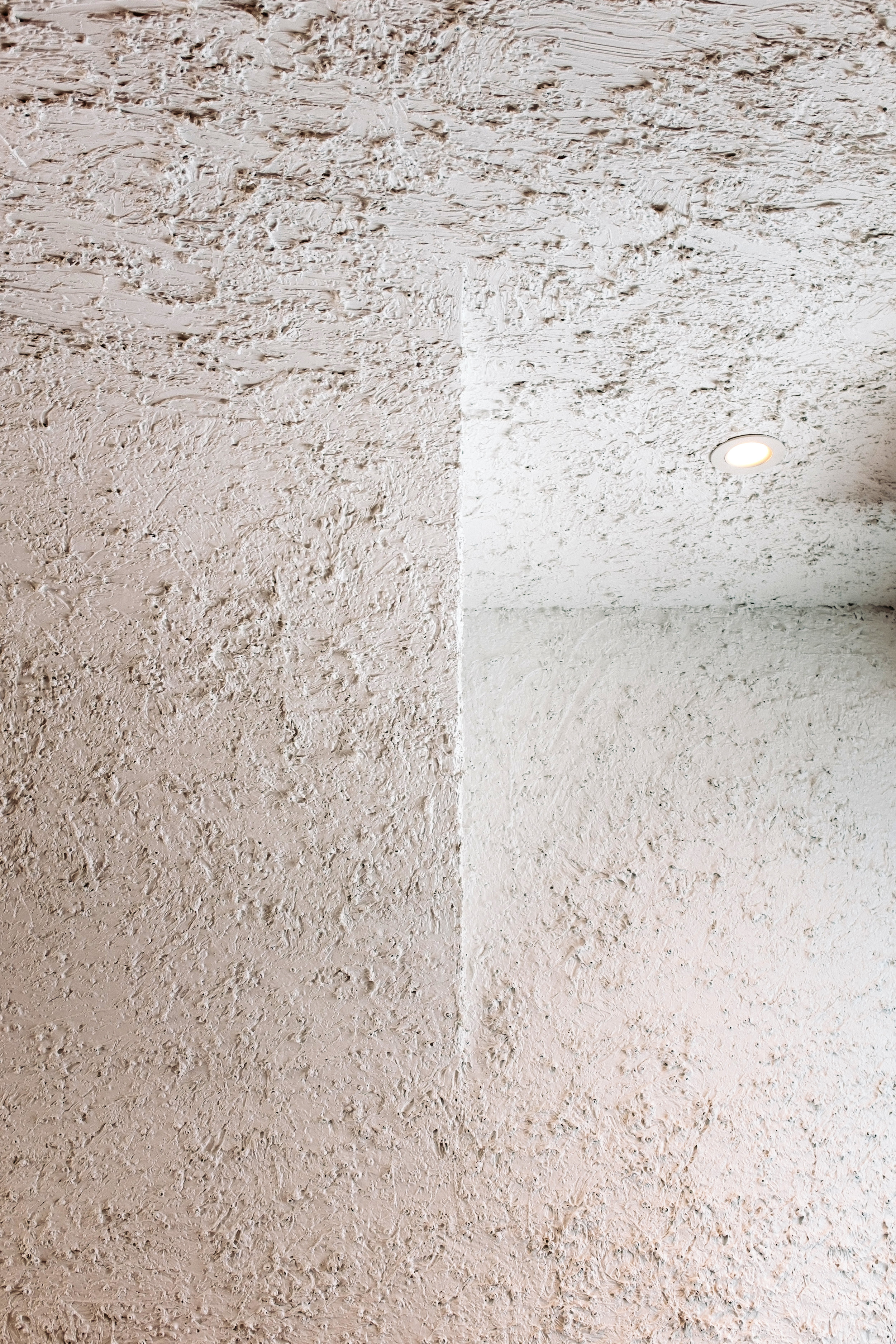 Detail of textured vaulted ceiling using plaster and recycled materials.