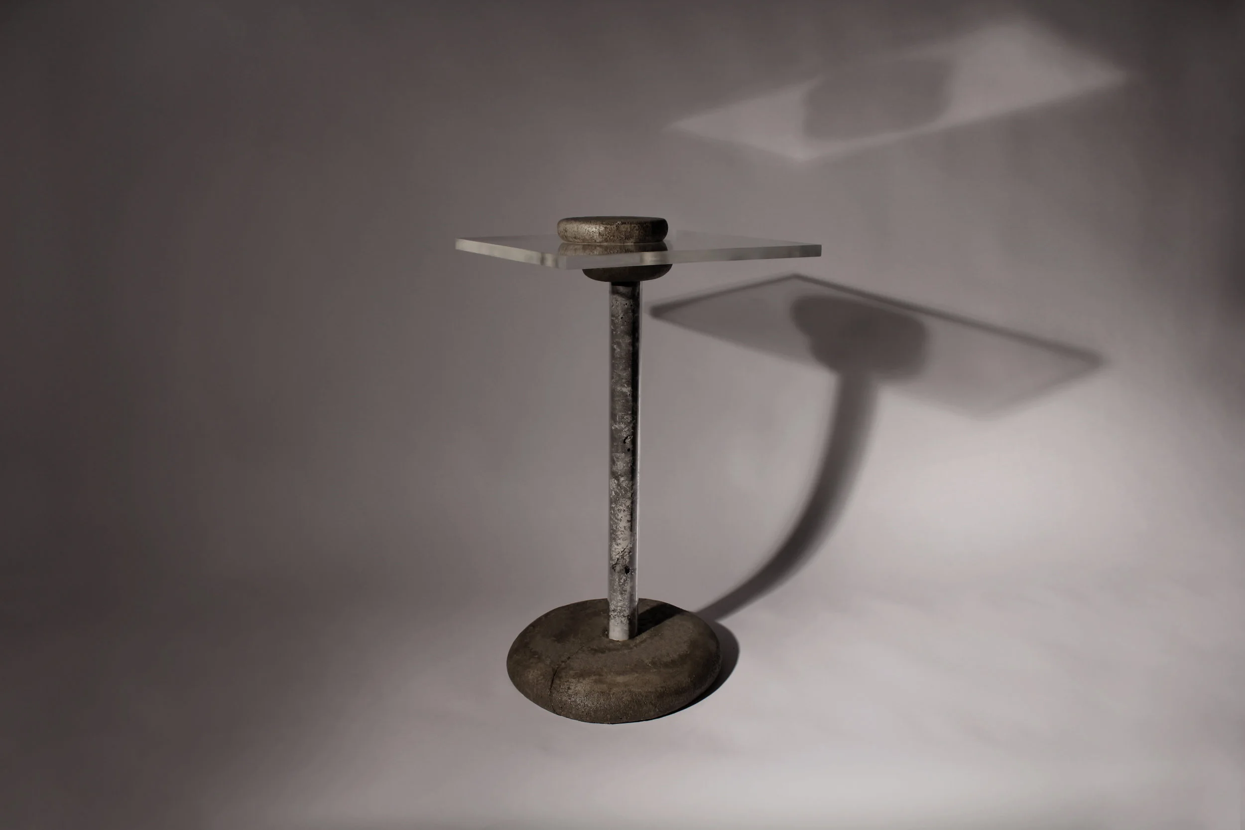 The plexiglass tabletop is held to the legs with fabric-formed joint pieces which create a removable form joint