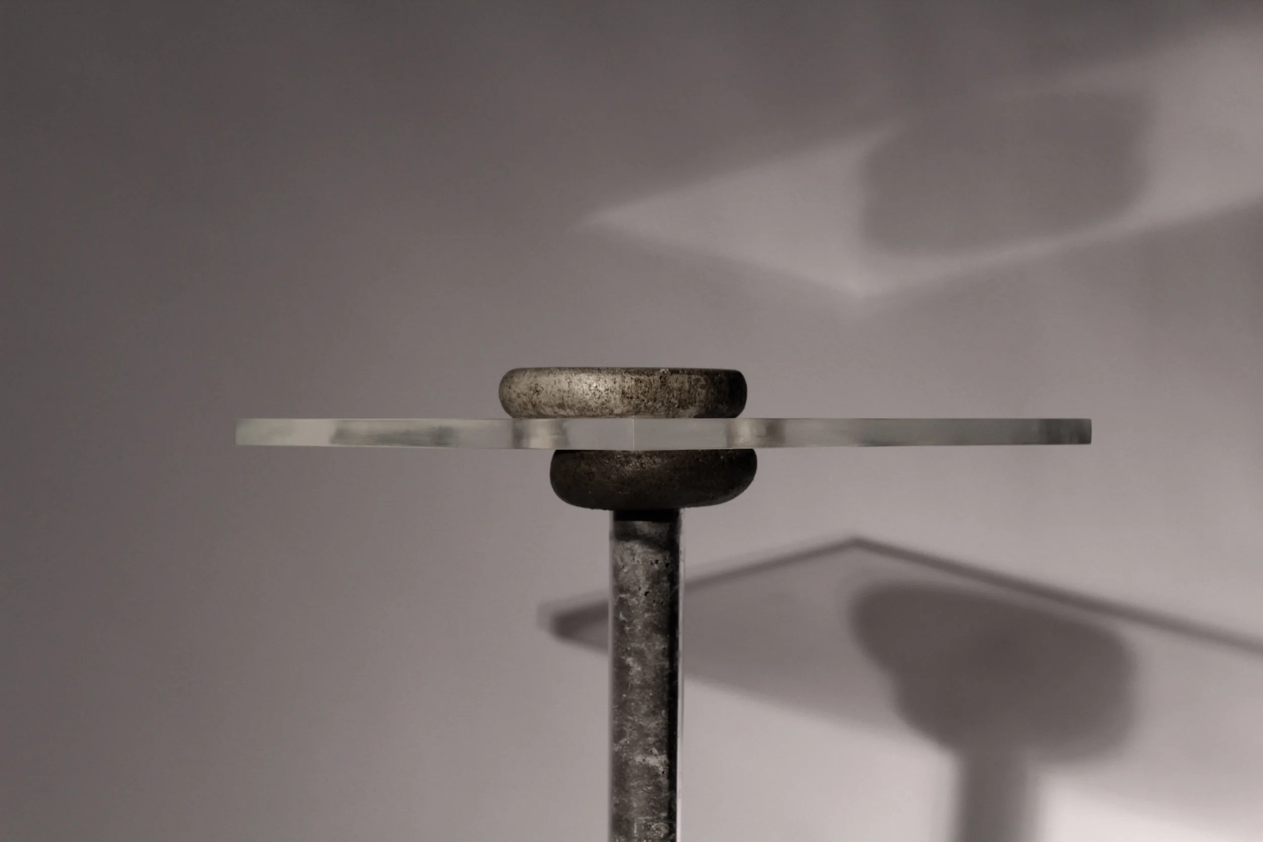 The plexiglass tabletop is held to the legs with fabric-formed joint pieces which create a removable form joint