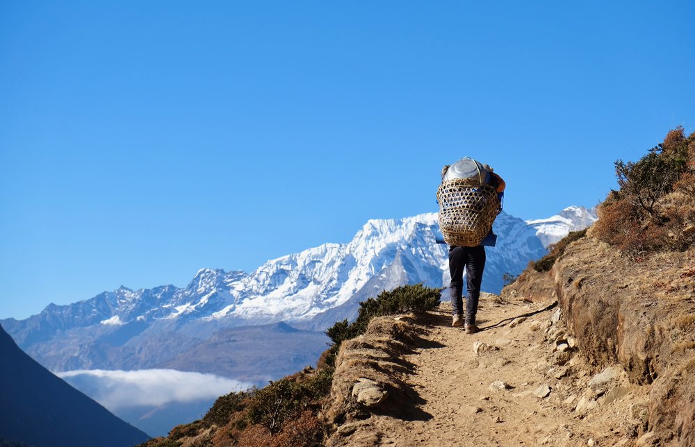 Porter summiting a ridge