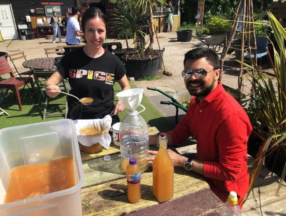 AIG volunteers filtering cider vinegar (May22)