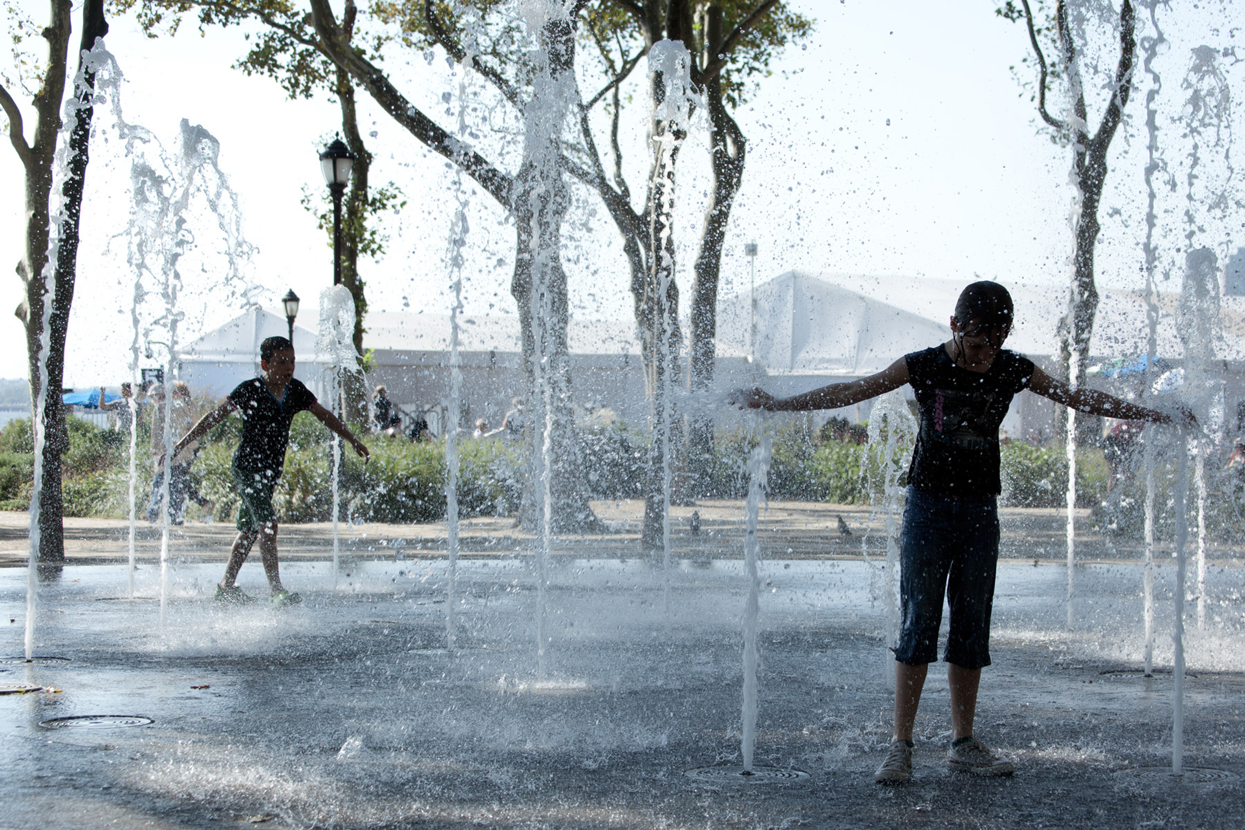 kids in water feature in battery park