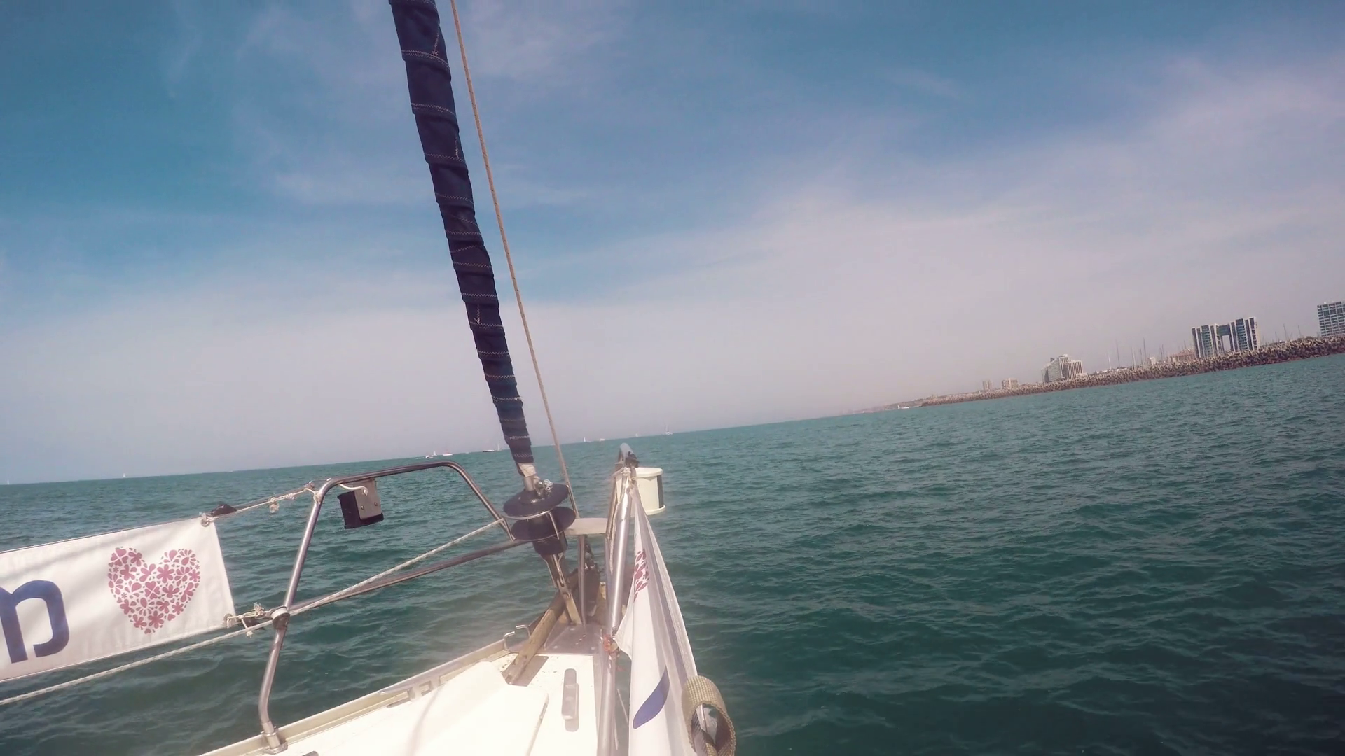 prow-of-a-sailboat-that-sail-in-mediterranean-sea-there-are-buildings-in-the-horizon_rpgq1bntc_thumbnail-full01.png