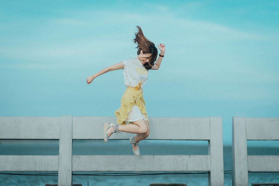 Woman Jumping Near Fence.jpeg