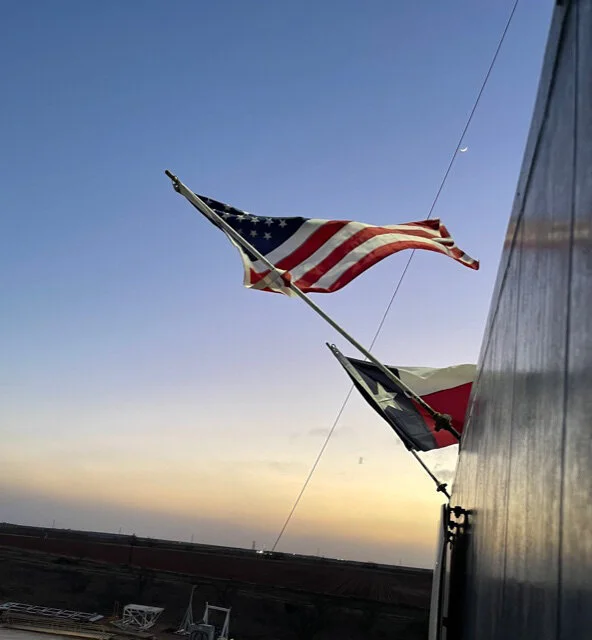 Flags on rig from rig floor.jpg