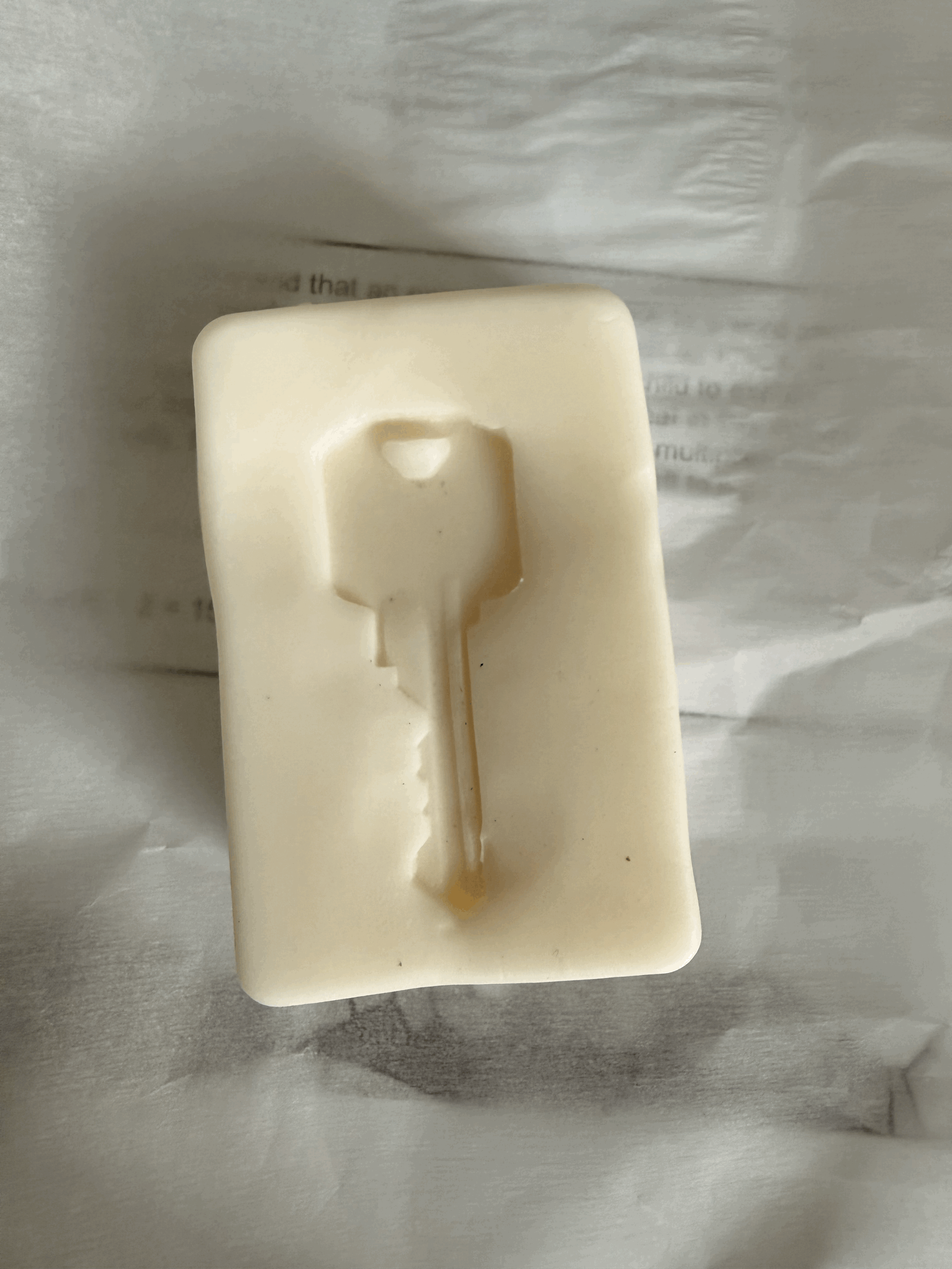 "Memory: the space in which a thing happens for the second time". Key from a deported woman imprinted onto goat milk soap. 2026.