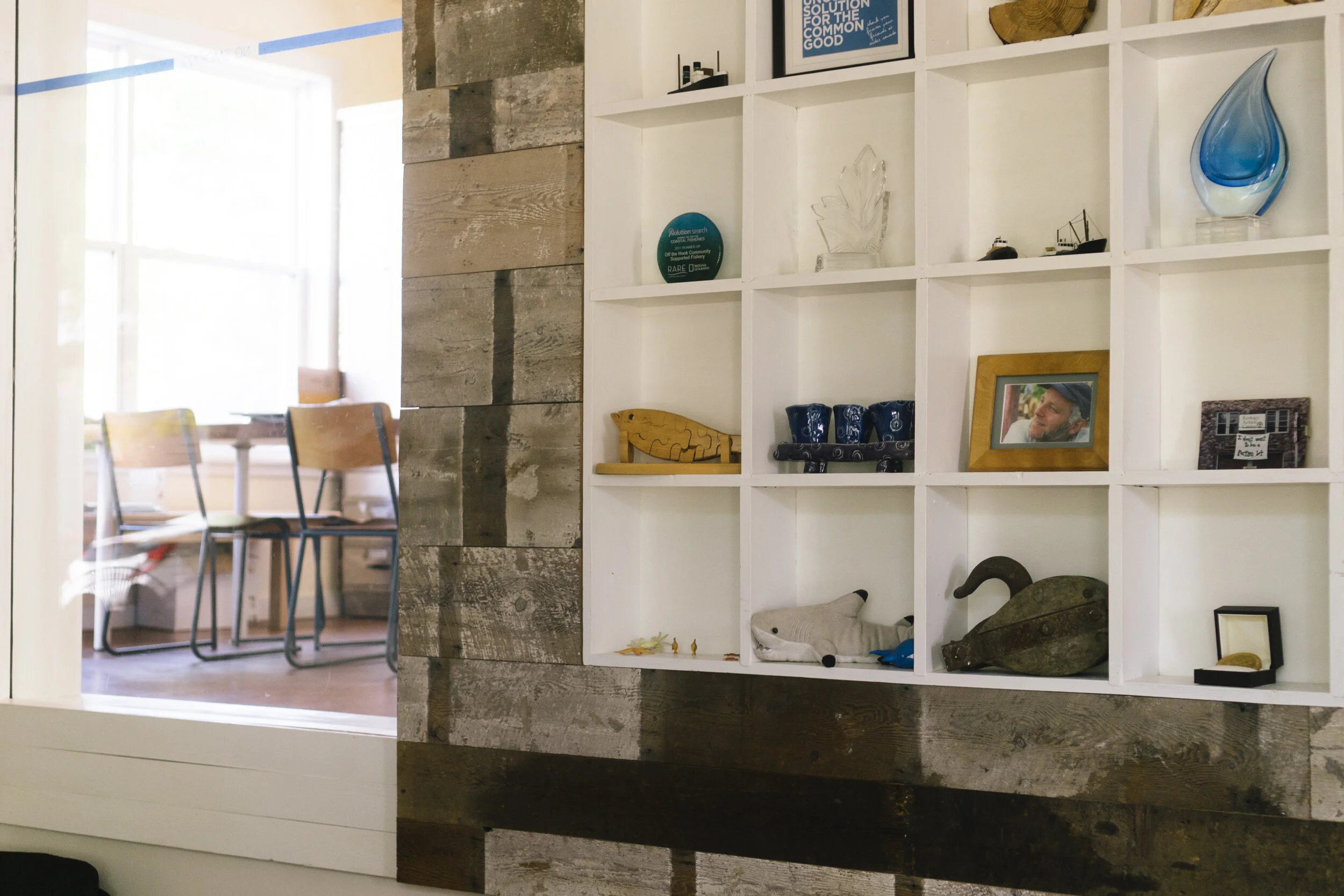 Repurposed subfloor boards are featured on the walls in the entry and the main level meeting room. These beautiful, old whitewashed floor boards were carefully salvaged during the deconstruction of part of the main level.