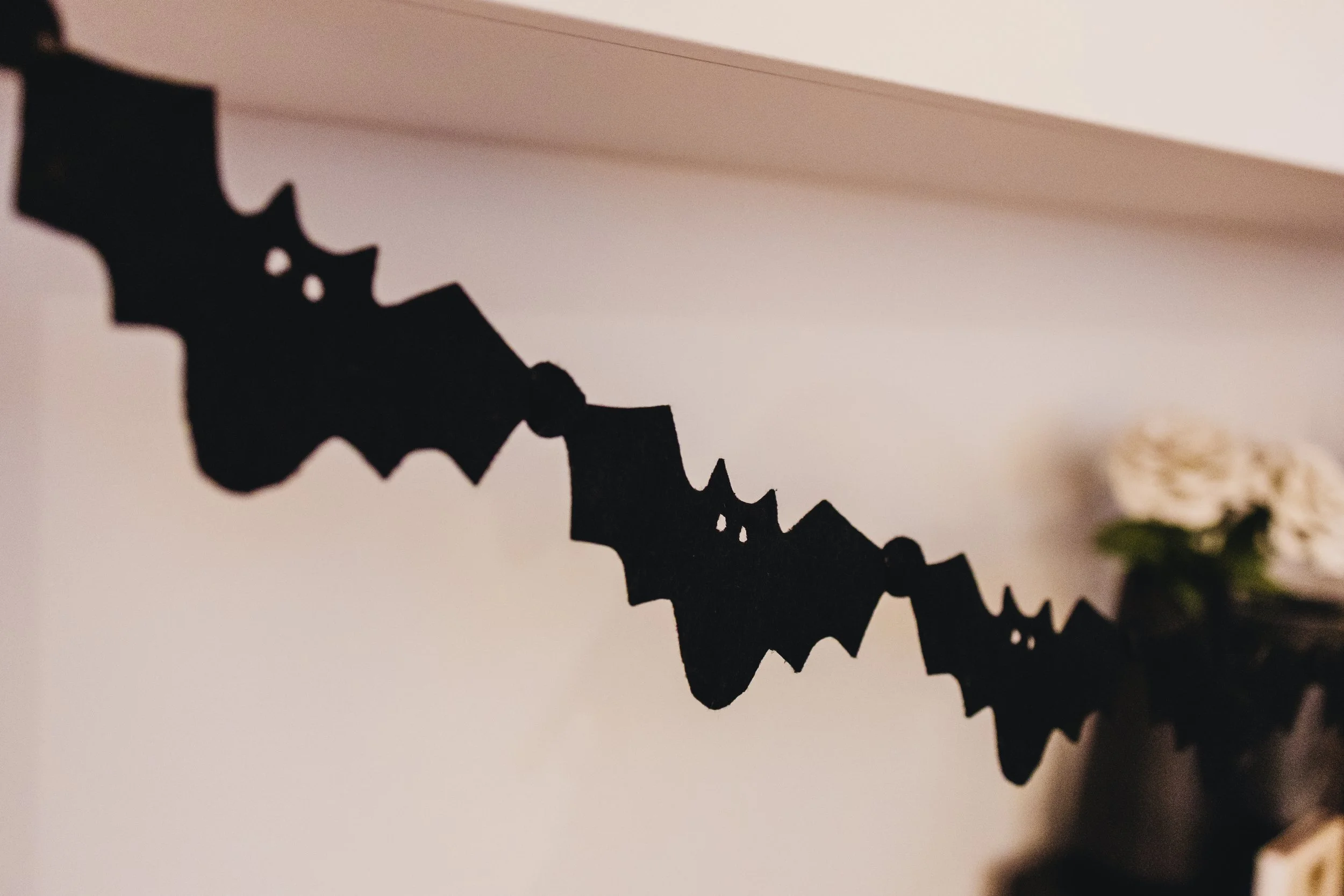 A strand of black, felt bats, connected at the wing tips