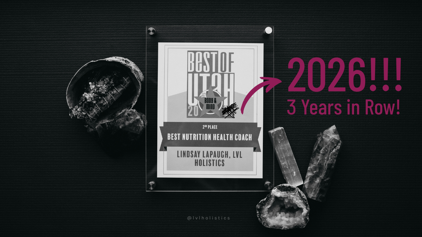 Best of Utah City Weekly award next to crystals on a yoga mat