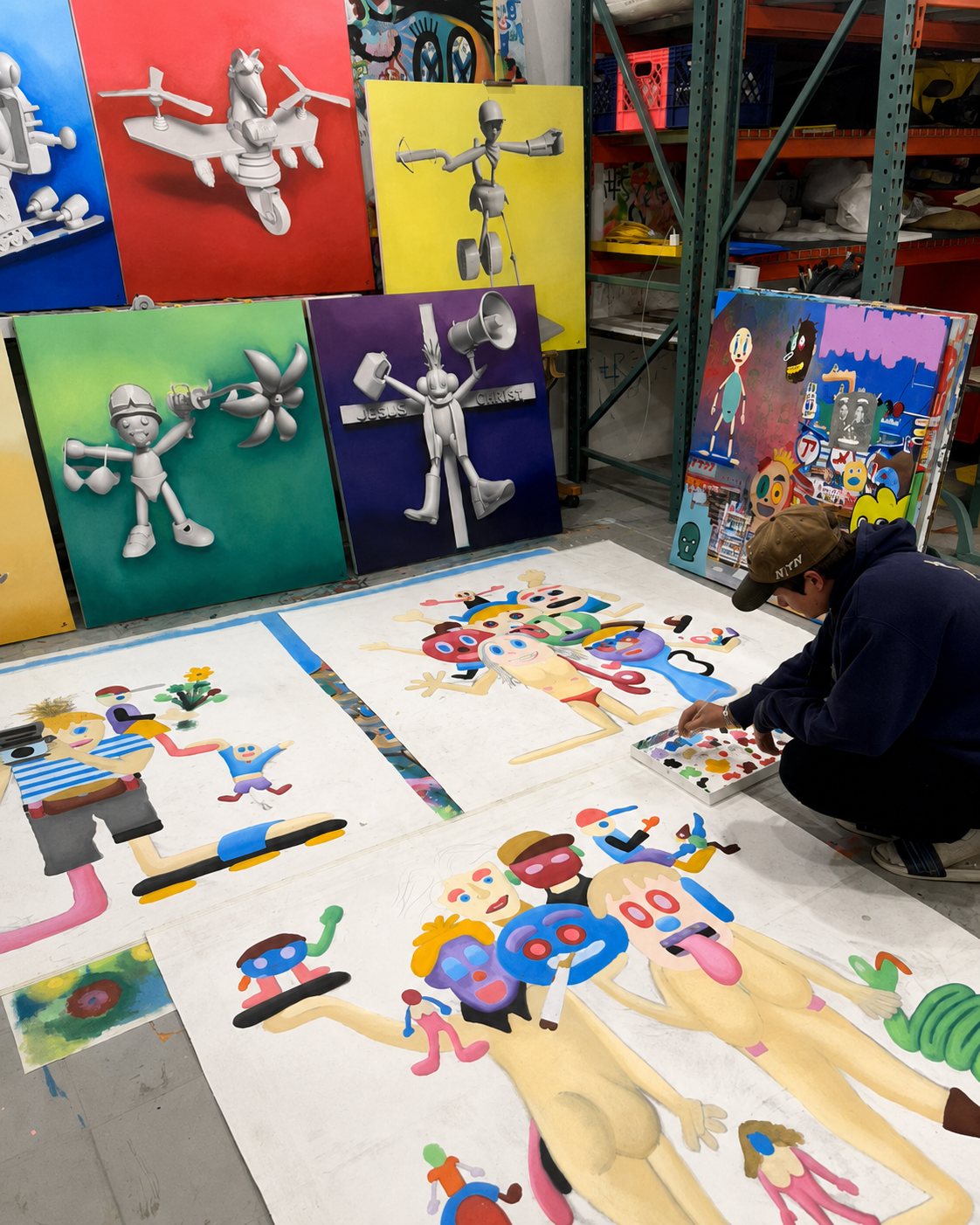 Alexander Reagan working among paintings and character studies in his studio