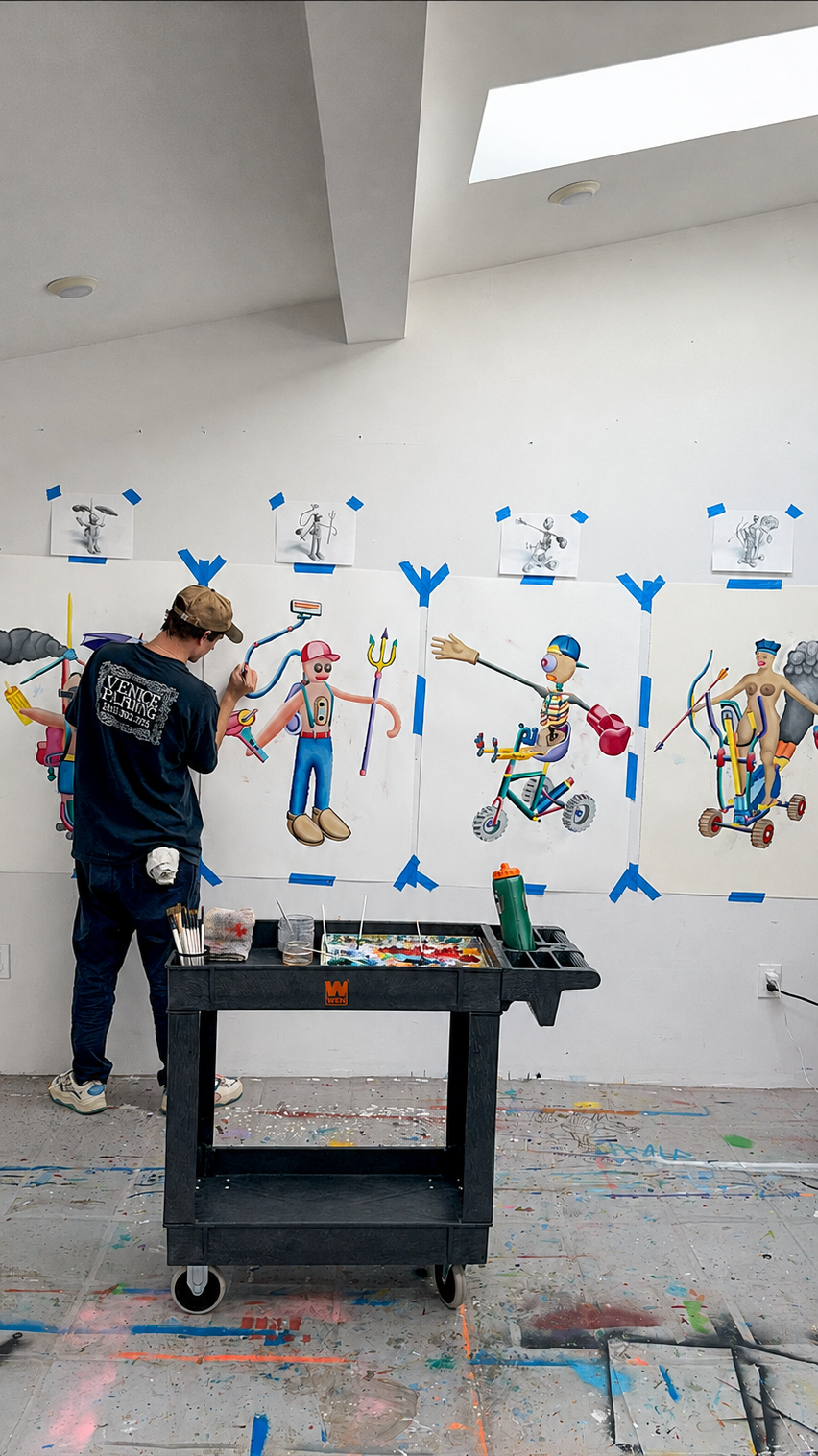 Artist Alexander Reagan painting colorful character artworks in his studio