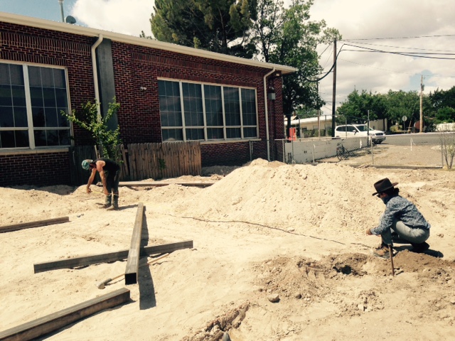  Volunteers Daniel Browning and Maryam Amiryani grade and level the ground for the playground. Photo by Nick Terry 