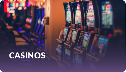 Casinos: row of illuminated slot machines glowing on a casino floor