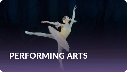 Performing arts: ballerina in a pink tutu balancing on pointe in a spotlit theatrical scene