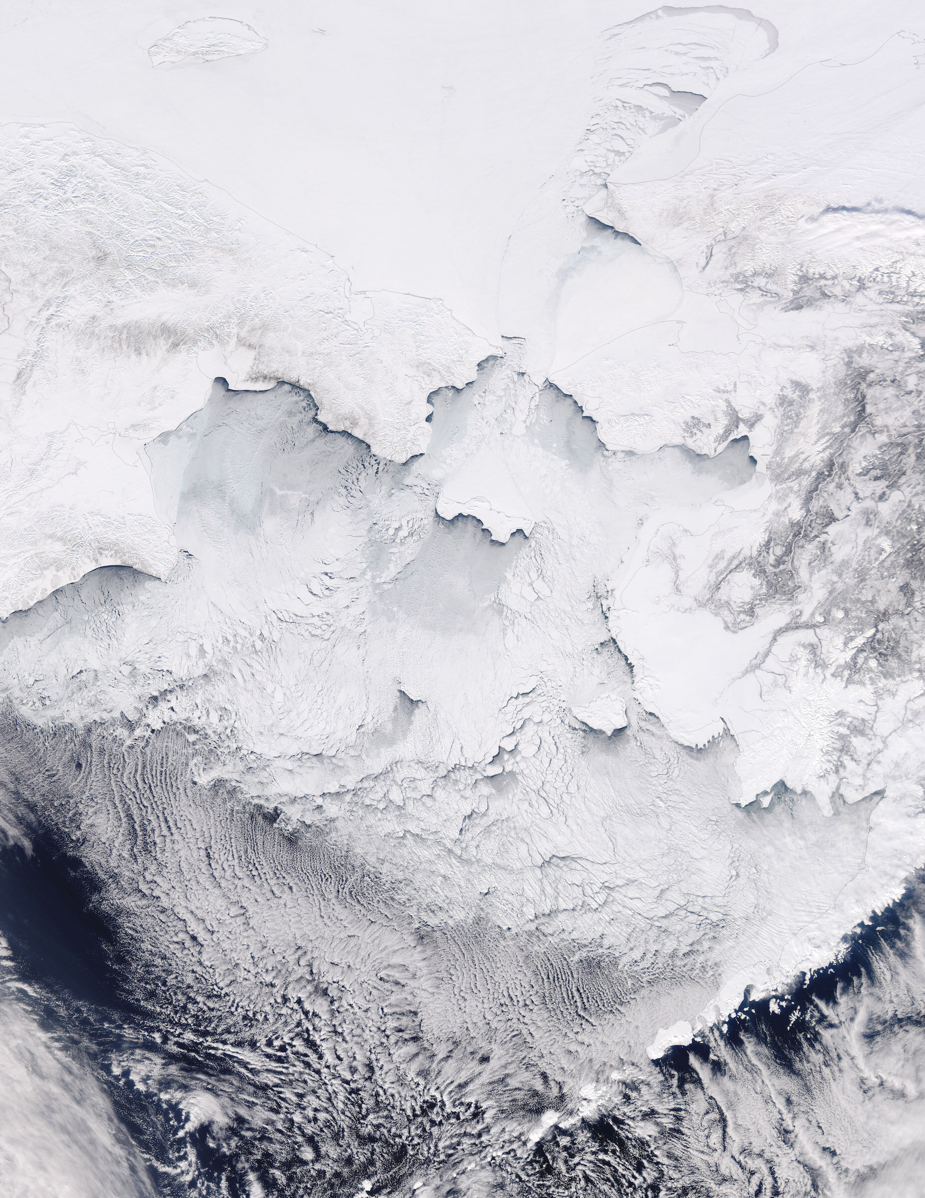 Alaska and Russia are covered in snow and ice. Photo by NASA
