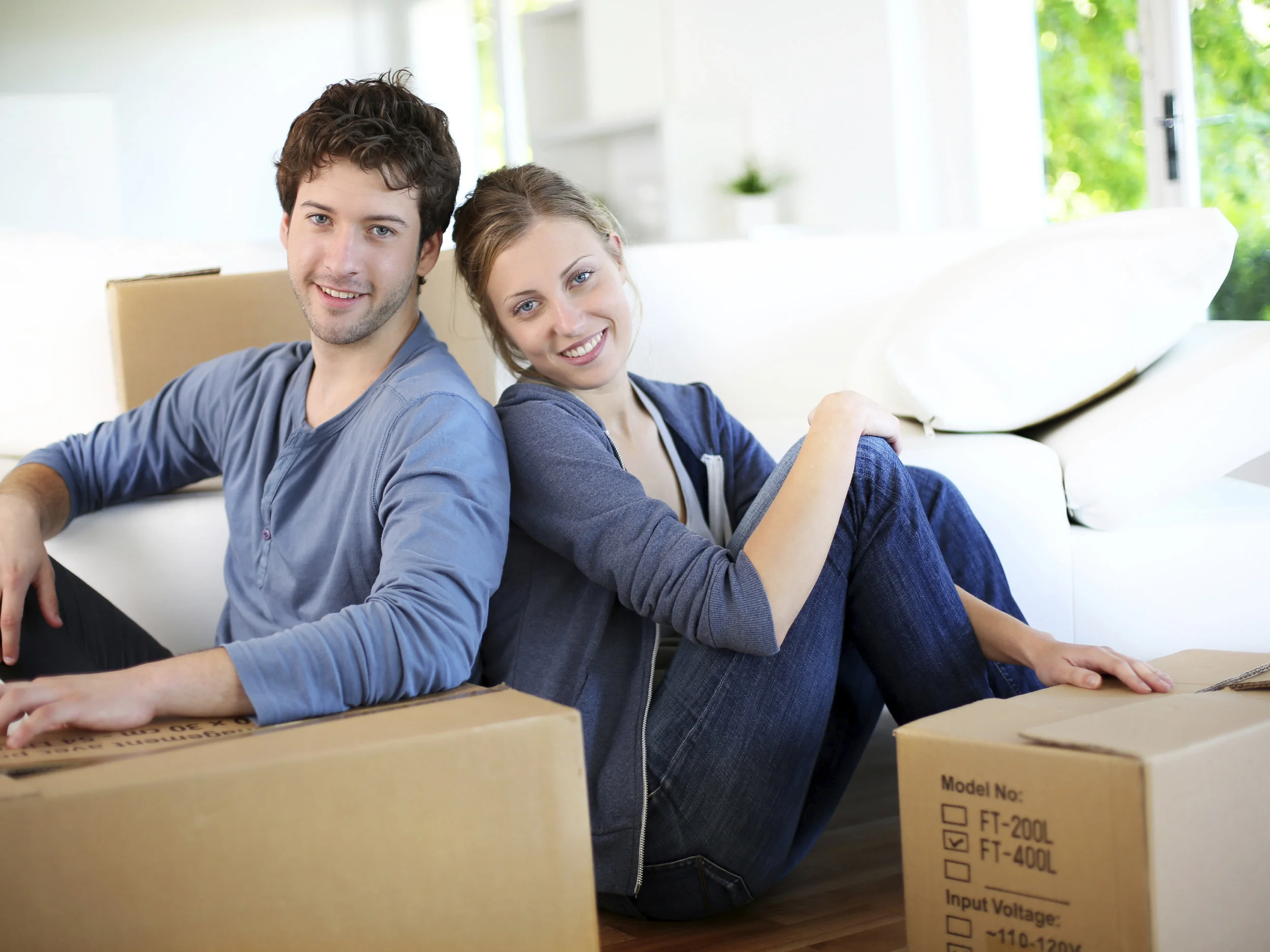 young-couple-sitting-in-house-with-boxes-mt2015.jpg