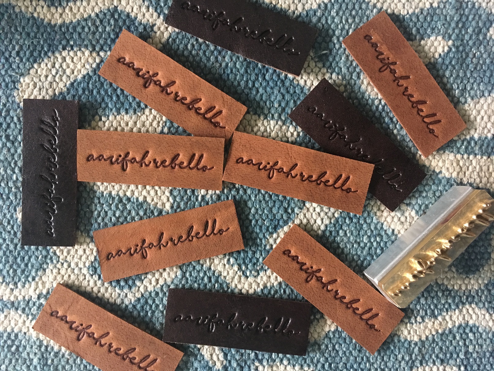 Aarifah Rebello emboss on tan and dark brown.jpeg