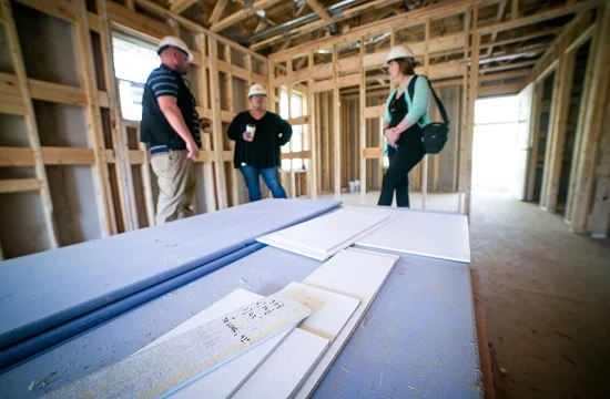 Pictured: Kelli Palmer, CFA Institute Director of Corporate Citizenship, during a walk-through at the Harmony Ridge neighborhood. CFA Institute is partnering with Habitat for Humanity on a pilot Carbon Offset Project in Harmony Ridge to help the non-profit maximize its use of energy-use reduction techniques and materials in the homes’ construction.
