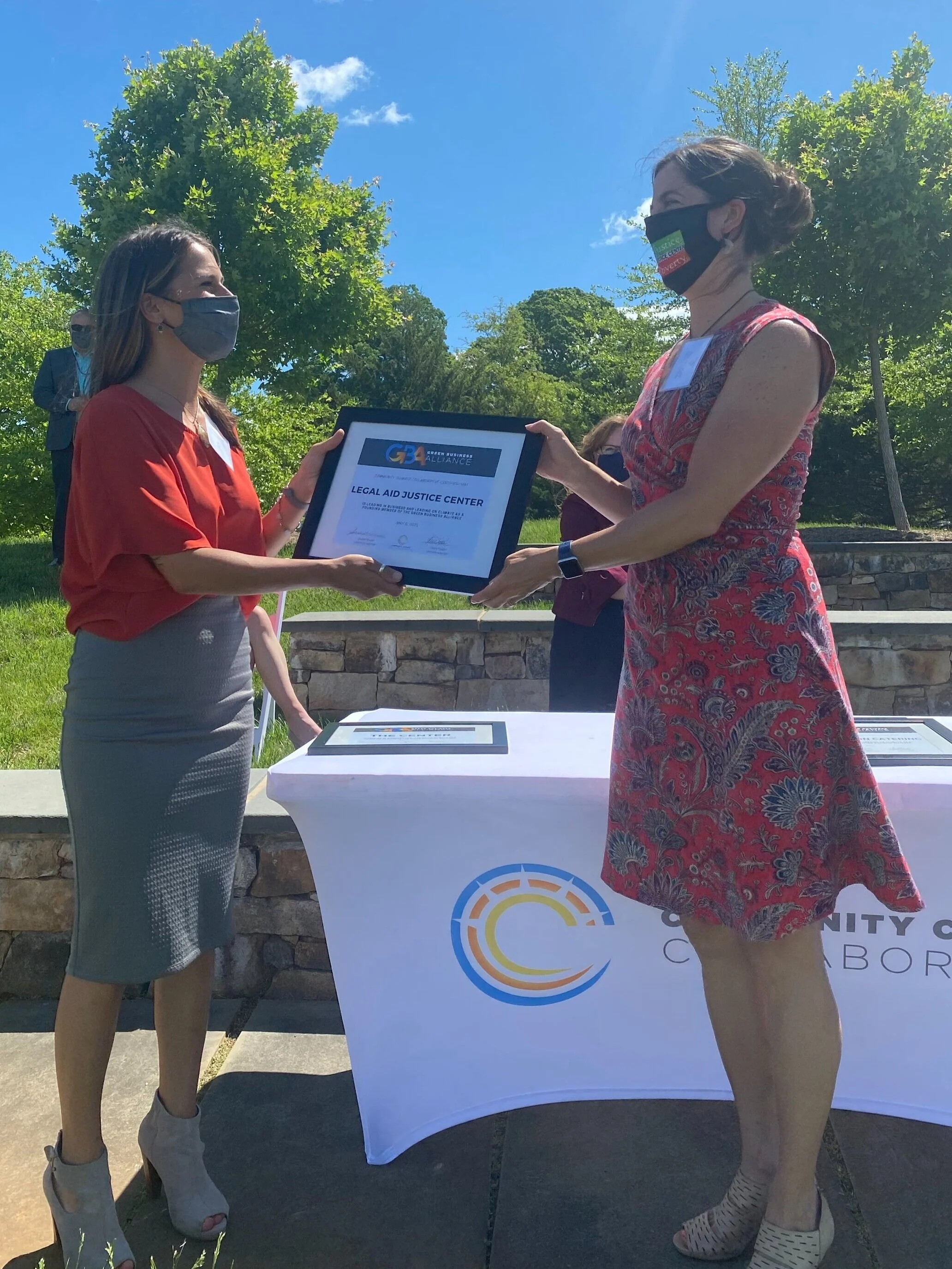 Claire Habel giving GBA Certificate of Membership to Angela Ciolfi of Legal Aid Justice Center