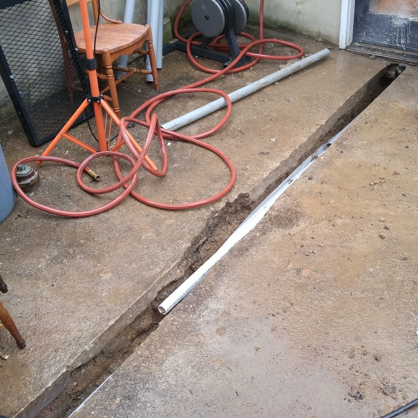Buried conduit was installed from the garage under the patio and kitchen and into the basement. The new power service would terminate in panels in the garage with 100 Amps sent back to the original main house panel in the basement.