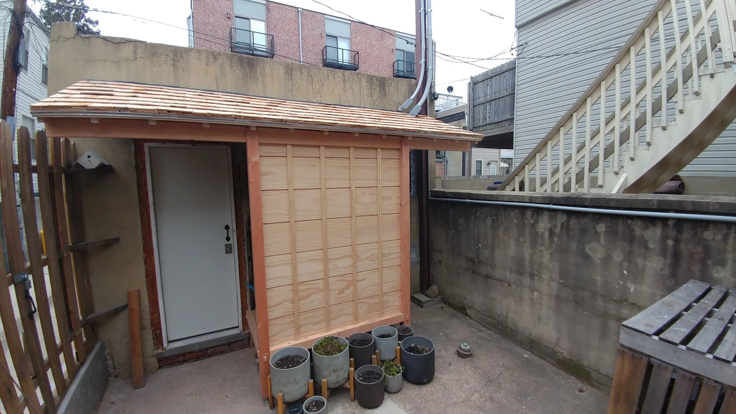 Inspired by Japanese design, this lean-to shed povides some cover to the entrance and extra storage.