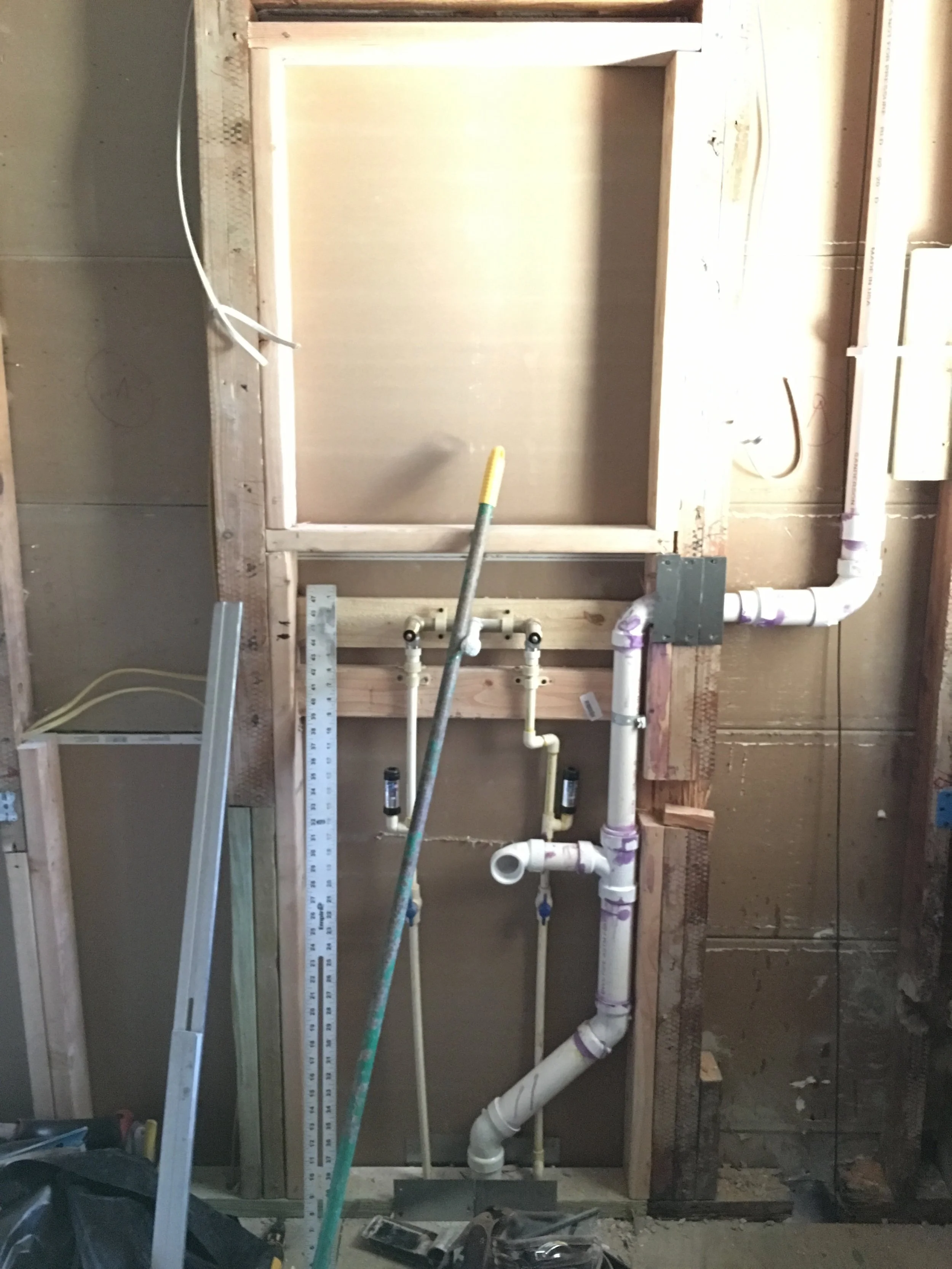 Rough plumbing (new drains, wall mounted faucet rough, and vent stack), medicine cabinet framing, rough electrical