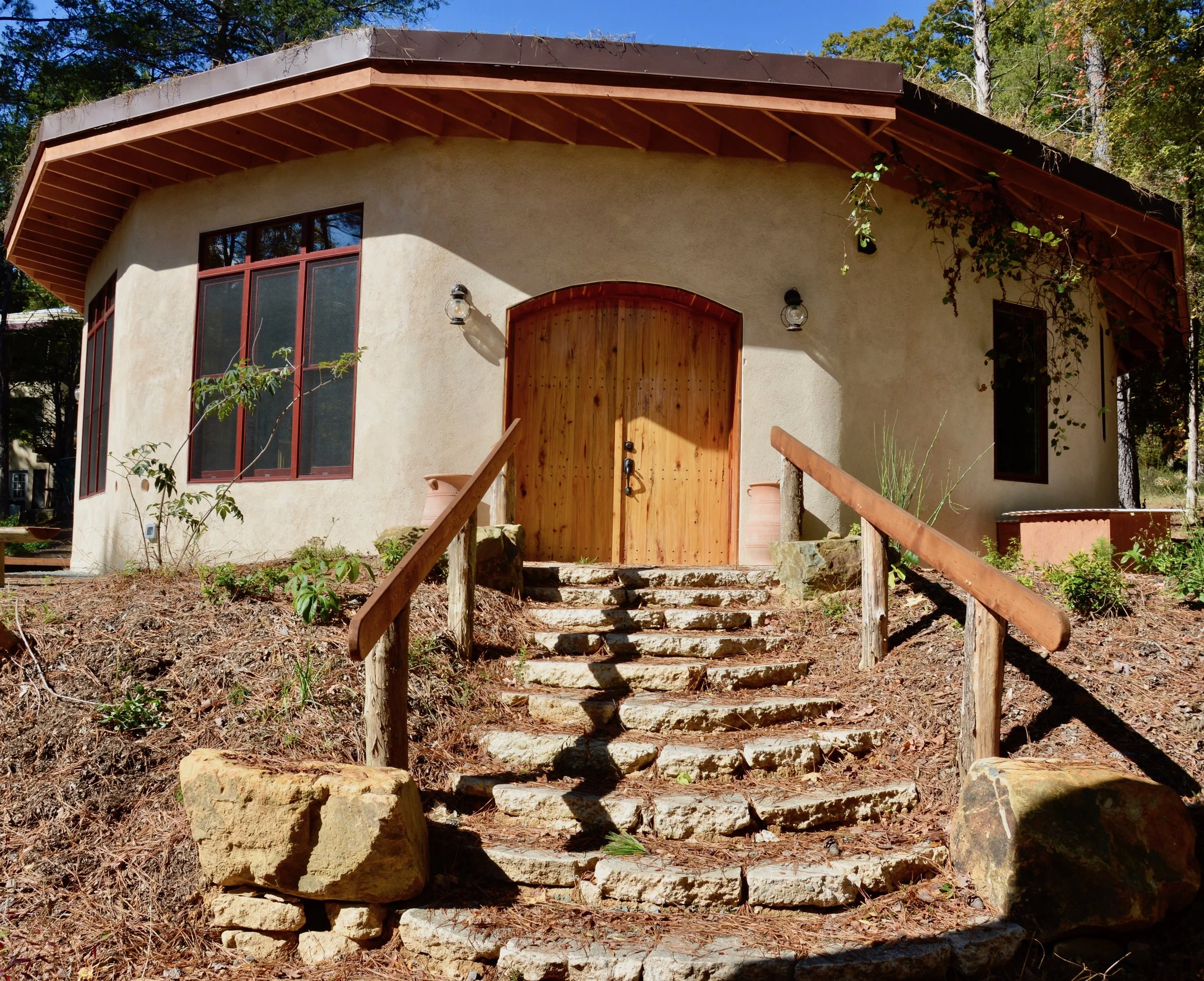  ECOHEAL CENTER The Ecoheal Center is a 1500 sq ft, 12-sided earthen building completed in the spring of 2017. Being the first commercial code-approved earthen building in the United States, the Ecoheal Center is an educational hub for those seeking an economic, practical, and efficient way to build naturally. Learn More →