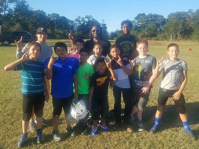 Cedric Benson teaches the Peewee Football League skill drills for a day.