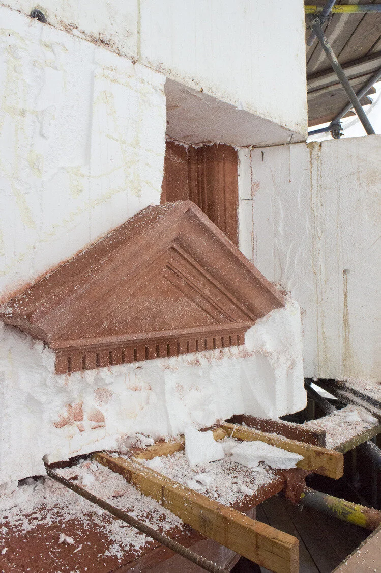 Cutting away of the formwork to reveal the ‘terracotta’ concrete beneath