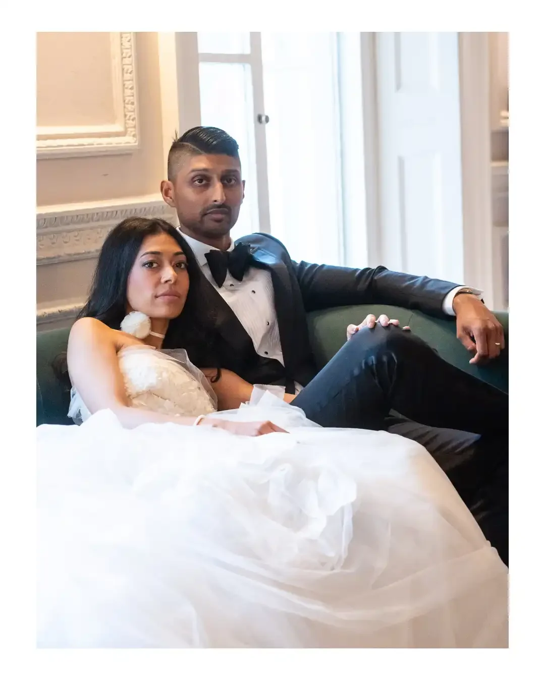 Wedding couple reclining on elegant chaise longue in Columbia Hotel