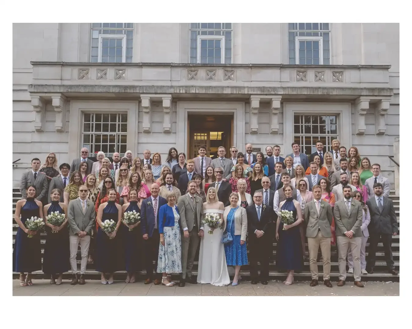 group photo of all wedding guests outside Hackney Town Hall