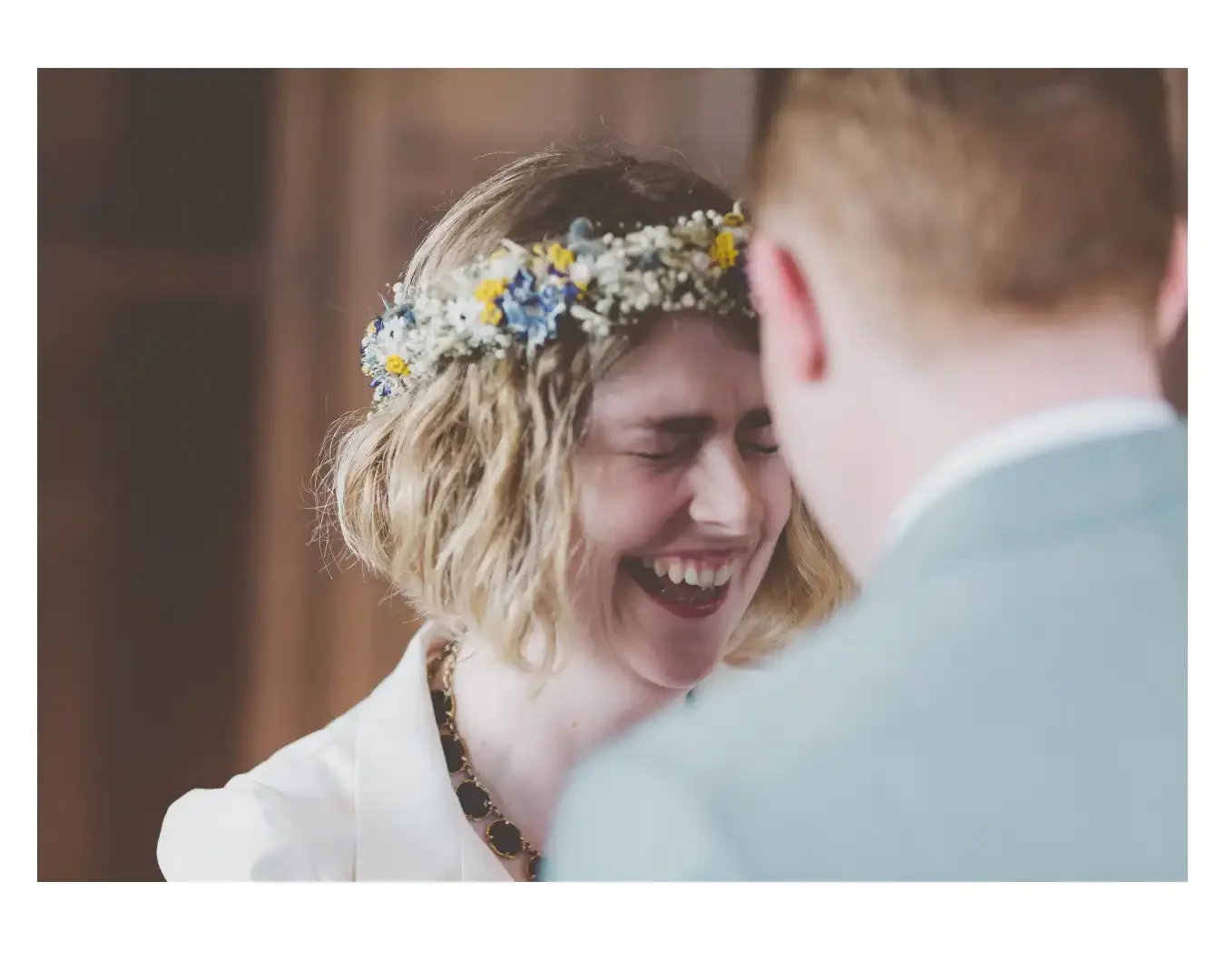 bride laughing during wedding ceremony