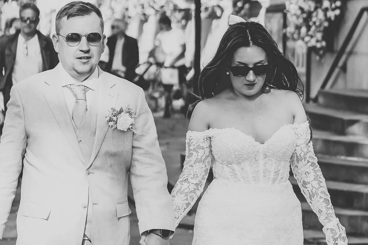 Black and white photo of wedding couple wearing sunglasses walking down Kings Road in celebrity editorial style